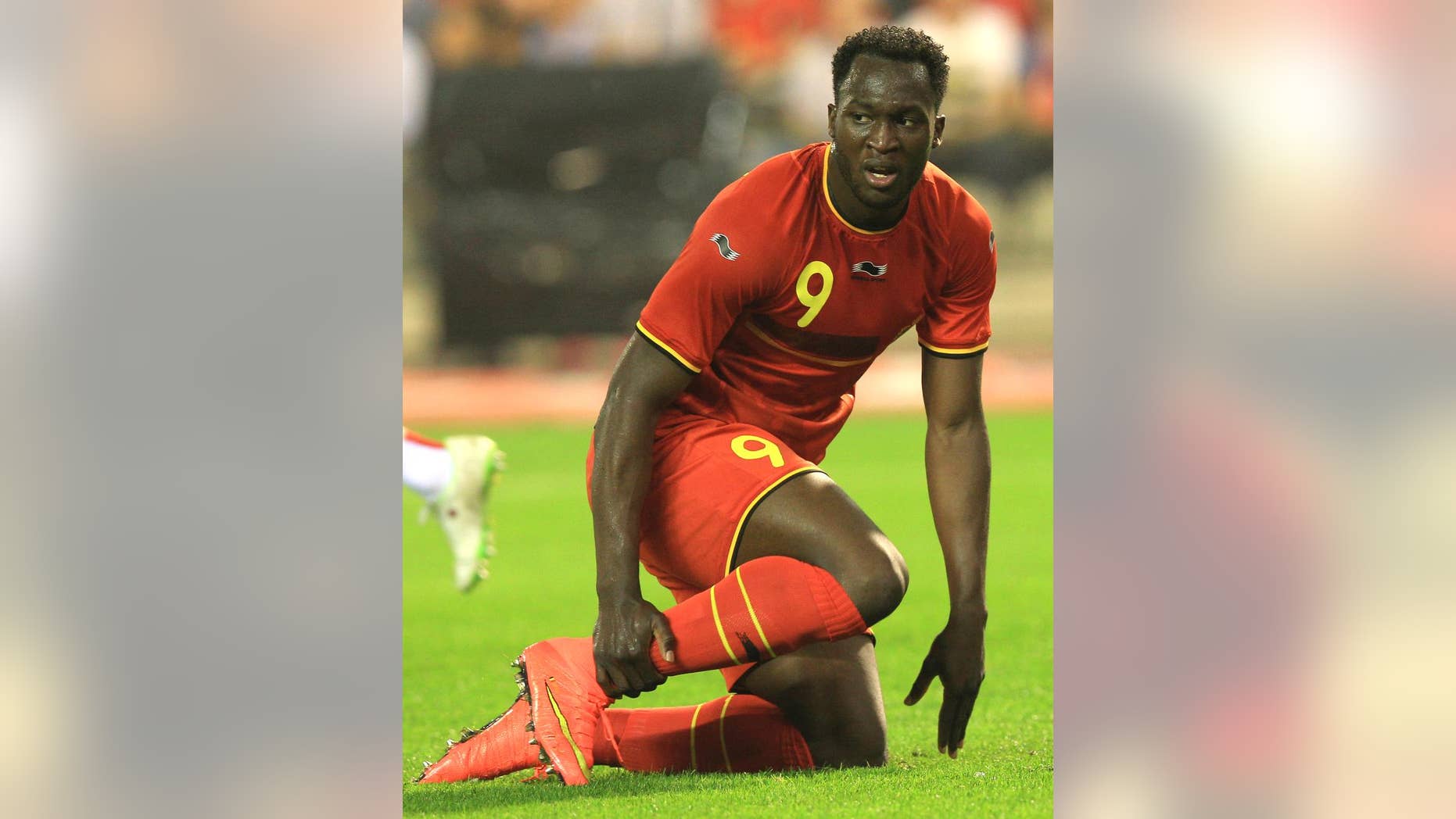 Belgium's Romelu Lukaku touches his ankle during a friendly soccer match against Tunisia, at the King Baudouin stadium in Brussels, Saturday, June 7, 2014. Belgium will play against South Korea, Russia and Algeria in Group H of the World Cup 2014 in Brazil. (AP Photo/Yves Logghe)