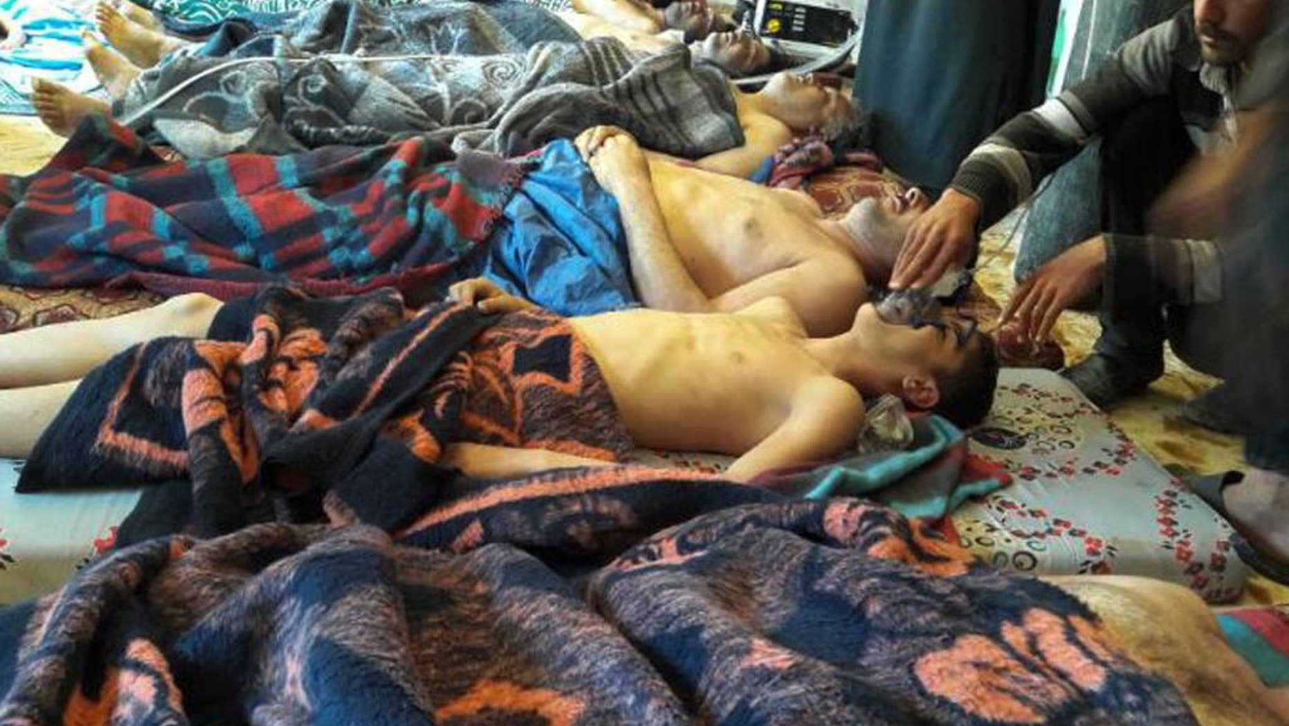 FILE - In this Tuesday, April 4, 2017 file photo, victims of the suspected chemical weapons attack lie on the ground, in Khan Sheikhoun, in the northern province of Idlib, Syria. Israeli defense officials say Syrian President Bashar Assad still has up to three tons of chemical weapons. The officials delivered the assessment on Wednesday, April 19, 2017, weeks after a chemical attack in Syria killed at least 90 people. (Alaa Alyousef via AP, File)