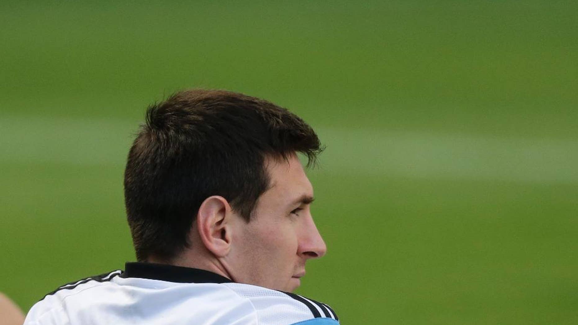 Argentina's Lionel Messi sits during a training session in Vespesiano, near Belo Horizonte, Brazil, Thursday, July 10, 2014. On Sunday, Argentina faces Germany for the World Cup final soccer match in Rio de Janeiro. (AP Photo/Victor R. Caivano)