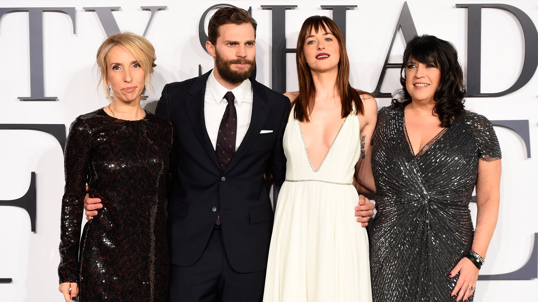 LONDON, ENGLAND - FEBRUARY 12: (L-R) Director Sam Taylor-Johnson, actors Jamie Dornan, Dakota Johnson and author E.L. James attend the UK Premiere of "Fifty Shades Of Grey" at Odeon Leicester Square on February 12, 2015 in London, England. (Photo by Ian Gavan/Getty Images)