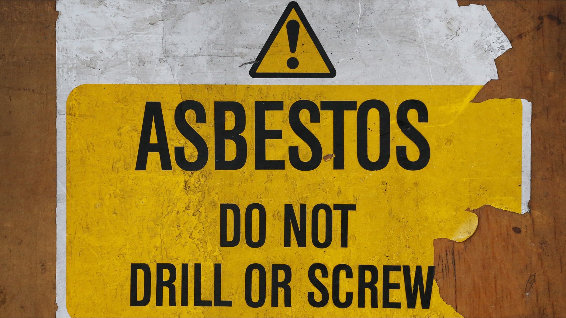 LONDON, ENGLAND - OCTOBER 11: A sign warns of asbestos danger at a former Royal Mail sorting office on October 11, 2013 in London, England. (Photo by Peter Macdiarmid/Getty Images)