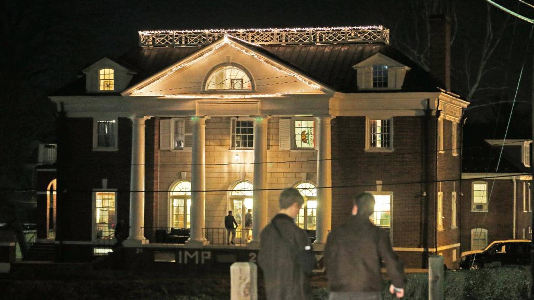 FILE - Students participating in rush pass by the Phi Kappa Psi house at the University of Virginia in Charlottesville, Va., in this Jan. 15, 2015 file photo. Now the Columbia Graduate School of Journalism is about to explain how it all went so wrong. The school's analysis of the editorial process that led to the November 2014 publication of "A Rape on Campus" will be released online at 8 p.m. EDT Sunday April 5, 2015. (AP Photo/Steve Helber, File)