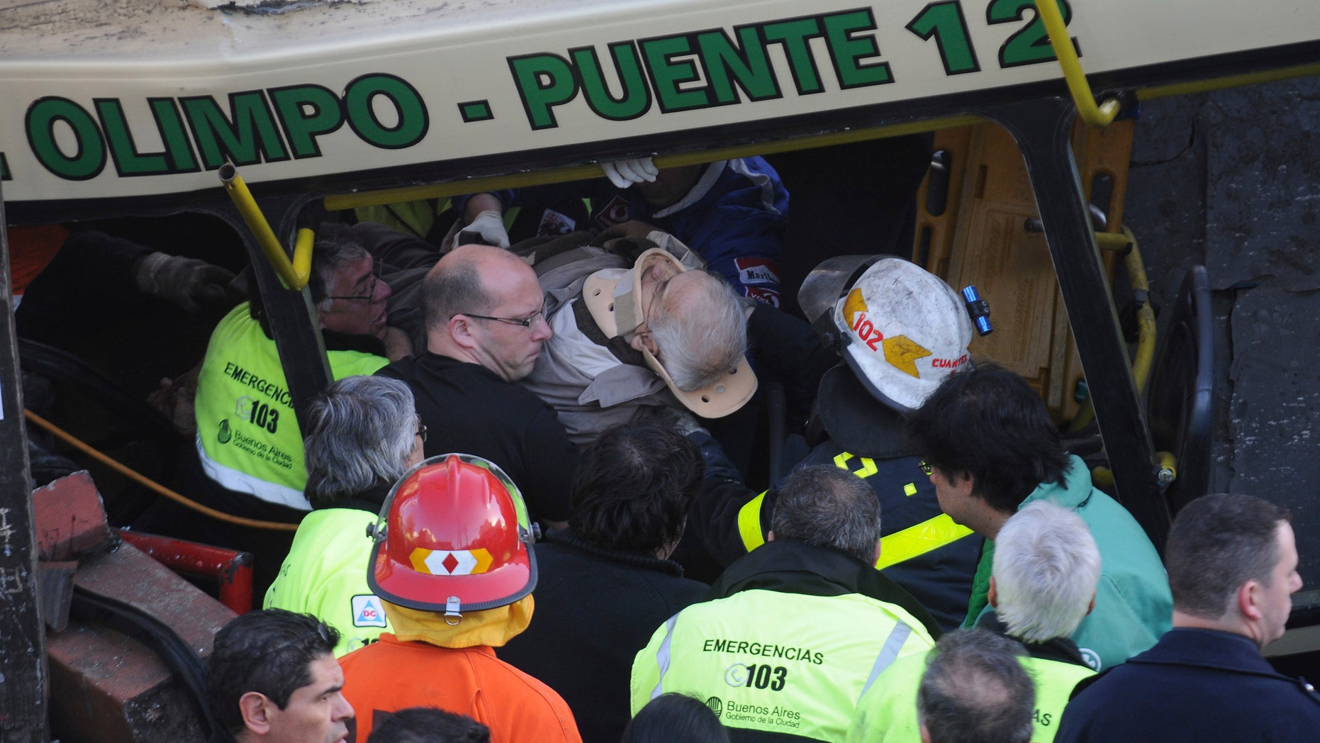A wounded passenger is carried out a train after it crashed in Buenos Aires, Argentina, Tuesday, Sept. 13, 2011. At least seven people were killed and at least 162 injured in a rush-hour crash Tuesday involving two passenger trains and a bus whose driver drove around barriers in an attempt to beat them across the tracks, Argentine authorities said.
