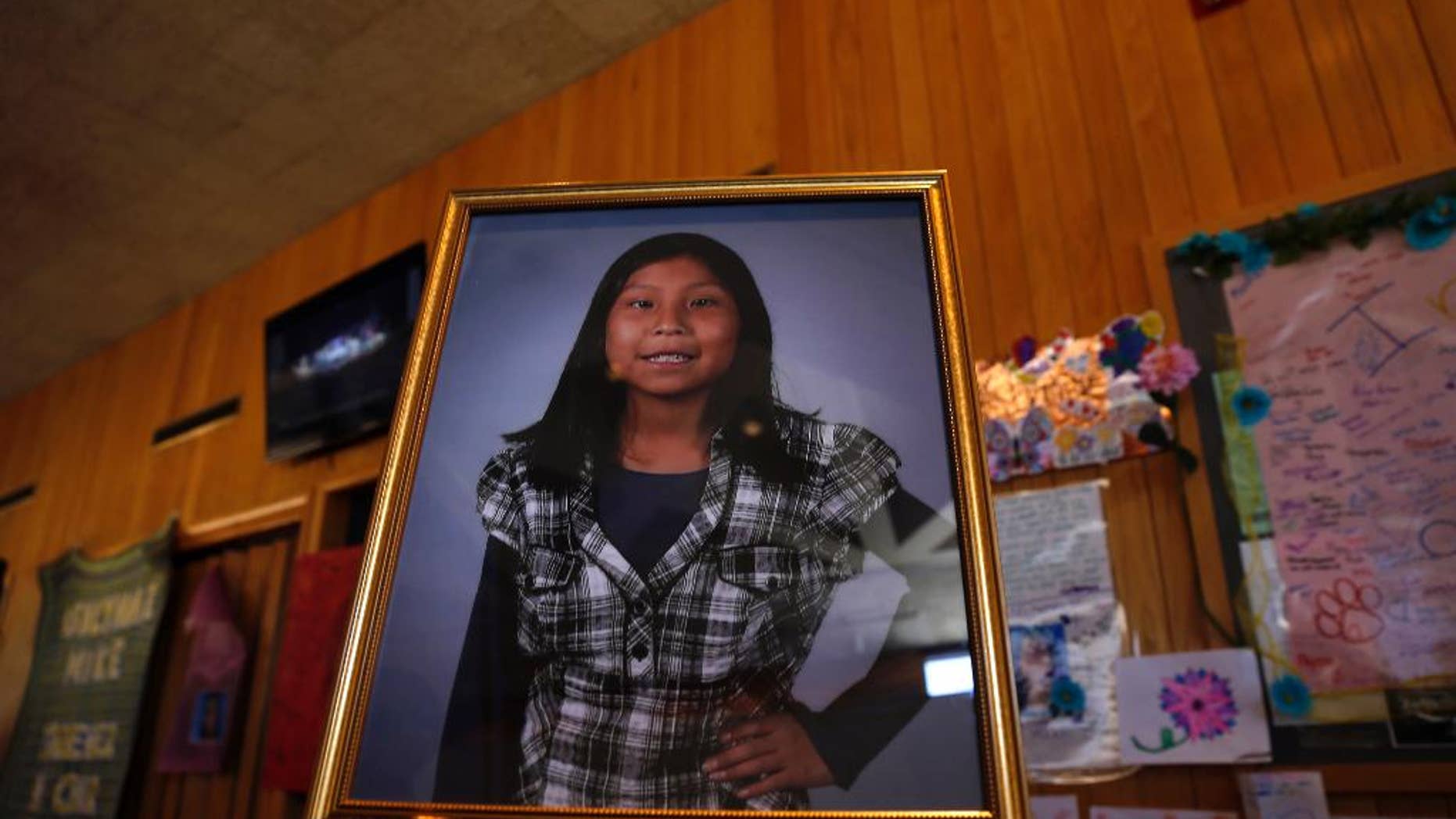 FILE - In this May 6, 2016 file photo a portrait of Ashlynne Mike is on display inside the lobby of the Farmington Civic Center in Farmington, N.M. Mike's father has sued the tribe for failing to have an emergency notification system that he claims would have saved his daughter's life. (Jon Austria /The Daily Times via AP, File)