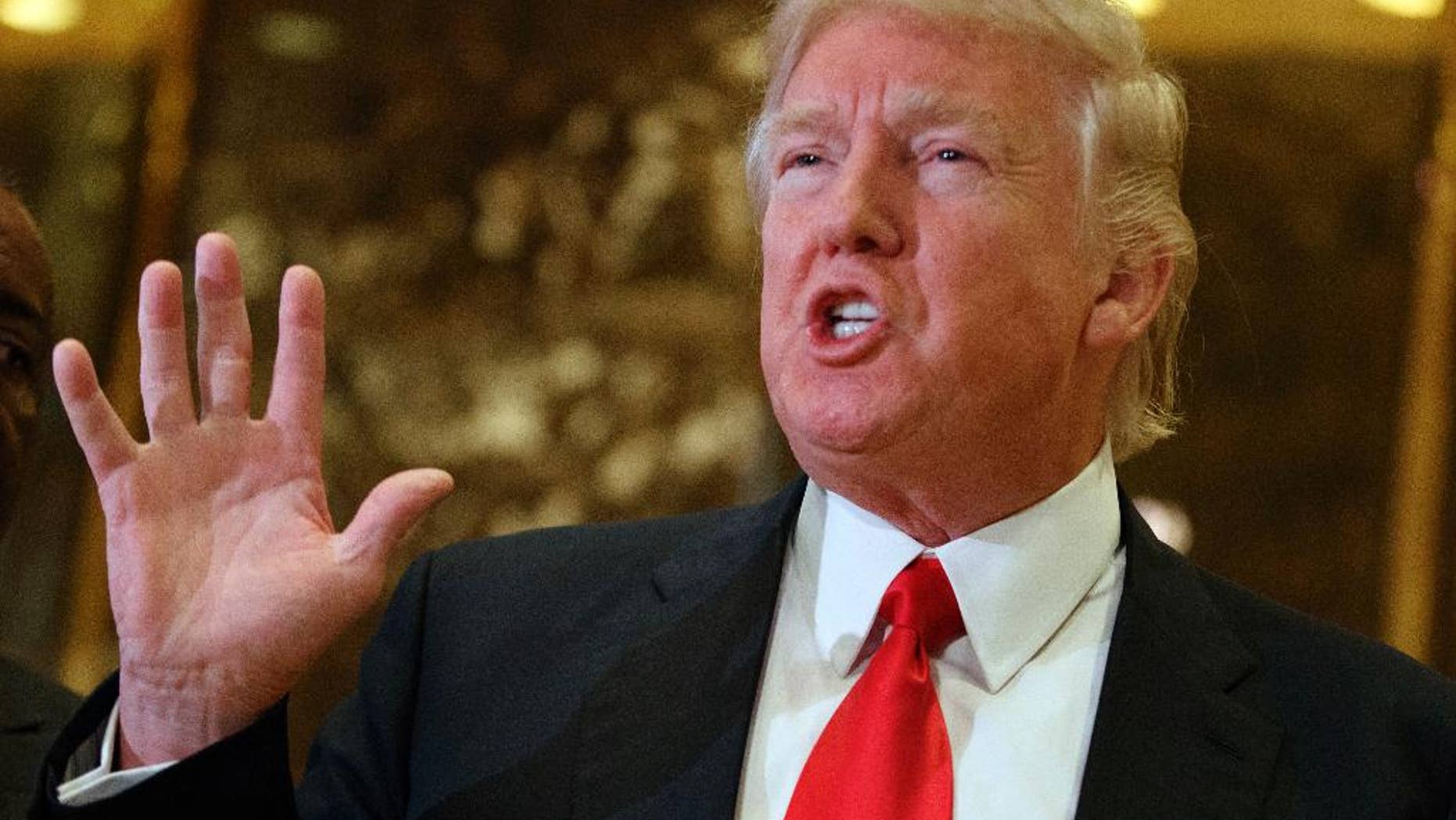 FILE - In this Jan. 13, 2017 file photo, President-elect Donald Trump speaks with reporters in the lobby of Trump Tower in New York. Trump has offered views on U.S. relations with Asia that could indicate radical shifts in long-standing policy toward the region. From opposing free trade agreements to confronting China and questioning Japan-South Korea alliances, he appears set to be charting a course far different from previous administrations. (AP Photo/Evan Vucci, File)