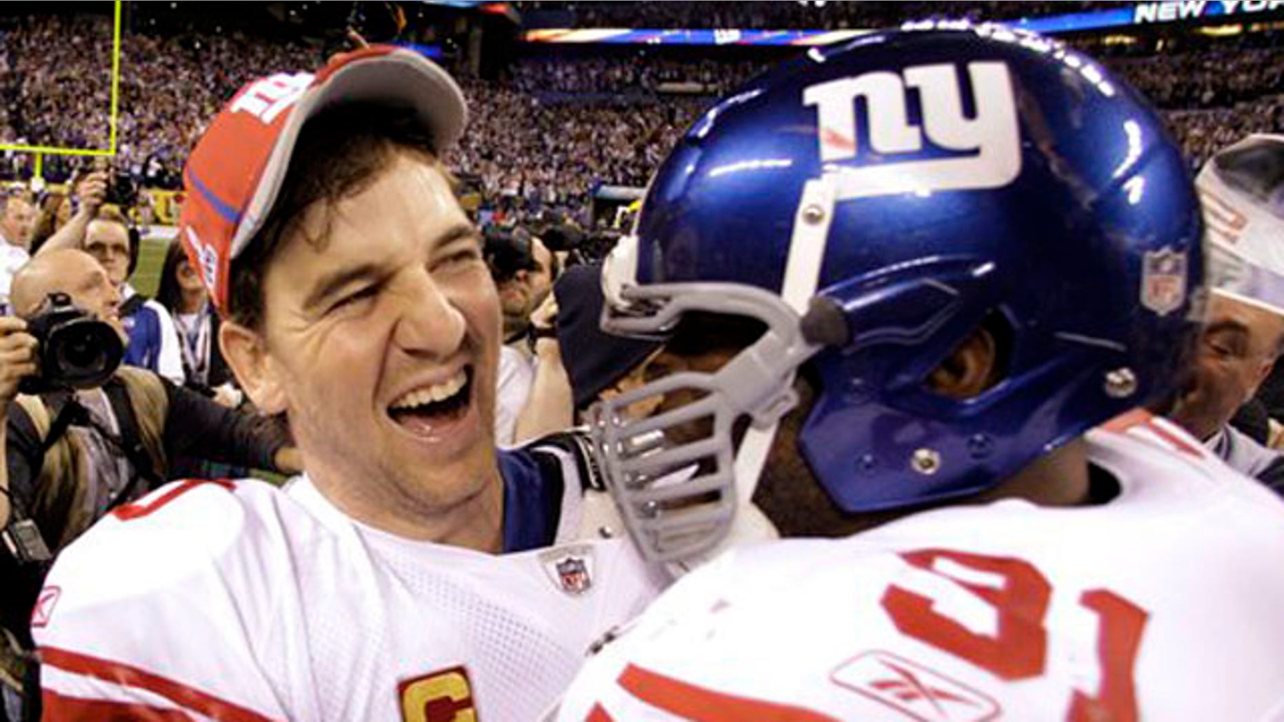 Feb. 5, 2012: New York Giants quarterback Eli Manning, left, and Justin Tuck celebrate their team's 21-17 win over the New England Patriots in the NFL Super Bowl XLVI football game in Indianapolis.