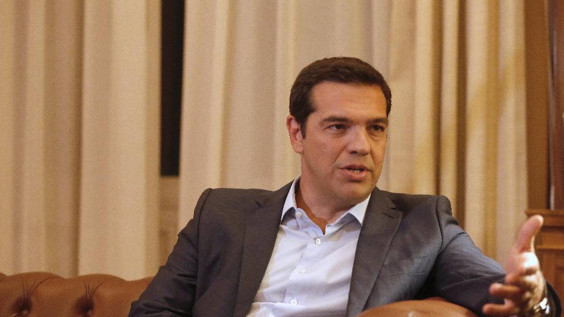 Greek Prime Minister Alexis Tsipras, meets with Greek President Prokopis Pavlopoulos, in Athens, Thursday, Aug. 20, 2015. Tsipras announced his government’s resignation and called early elections Thursday, seeking to consolidate his mandate to implement a new three-year international bailout that sparked a rebellion within his radical left Syriza party. (AP Photo/Petros Giannakouris)