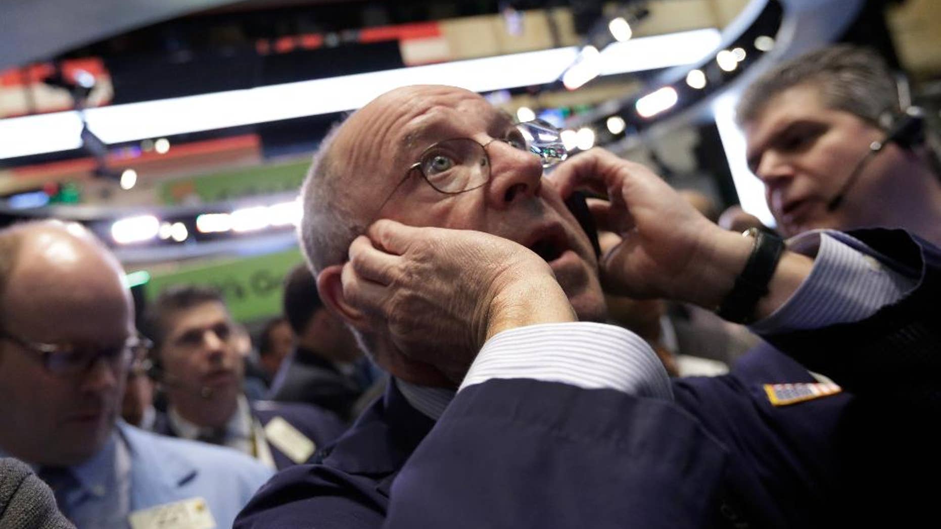 Trader Frederick Reimer works on the floor of the New York Stock Exchange, Wednesday, April 1, 2015. U.S. stocks moved lower in early trading Wednesday, extending losses from the day before. A report indicating that U.S. businesses slowed their pace of hiring last month weighed on the market. (AP Photo/Richard Drew)