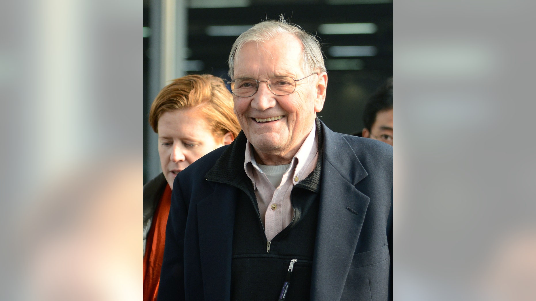 U.S. tourist Merrill Newman smiles upon arrival at Beijing airport Saturday, Dec. 7, 2013 after being released by North Korea. North Korea deported Newman who was detained for more than a month, apparently ending the saga of his return to the North six decades after he advised South Korean guerrillas still loathed by Pyongyang. North Korea made the decision because the 85-year-old Newman had apologized for his alleged crimes during the Korean War and because of his age and medical condition, according to the North's official Korean Central News Agency. (AP Photo/Kyodo News) JAPAN OUT, CREDIT MANDATORY