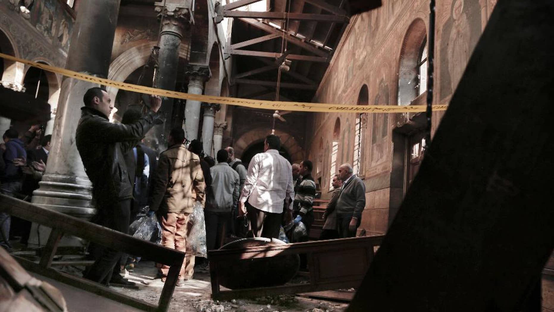 Security forces examine the scene inside the St. Mark Cathedral in central Cairo.