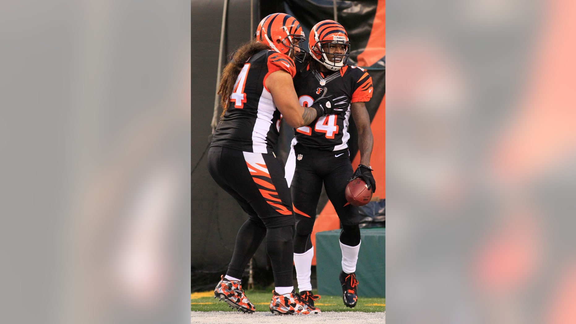 Cincinnati Bengals cornerback Adam Jones (24) is congratulated by defensive tackle Domata Peko (94) after Jones returned an interception 60 yards for a touchdown in the second half of an NFL football game against the New York Jets, Sunday, Oct. 27, 2013, in Cincinnati. Cincinnati won 49-9. (AP Photo/Tom Uhlman)