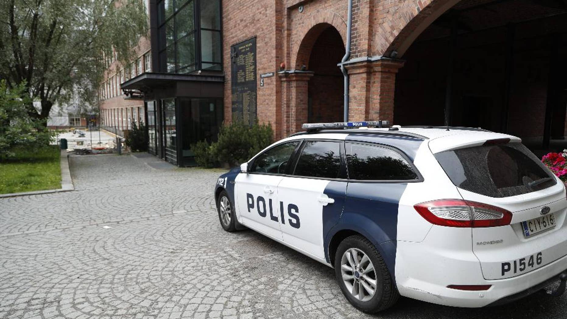 In this photo taken on Tuesday, July 5, 2016, a police car is parked outside Pirkanmaa district court in Tampere Finland. A Finnish prosecutor has charged six members of the Cuban national volleyball team with aggravated rape. Prosecutor Leena Koivuniemi says all six have denied the charges. She declined Tuesday, Aug. 16 to give further details pending the court case. Eight Cuban players were originally arrested following allegations that a woman was raped at a hotel where the team was staying in the city of Tampere. Two were later released. (Kalle Parkkinen/Lehtikuva via AP)