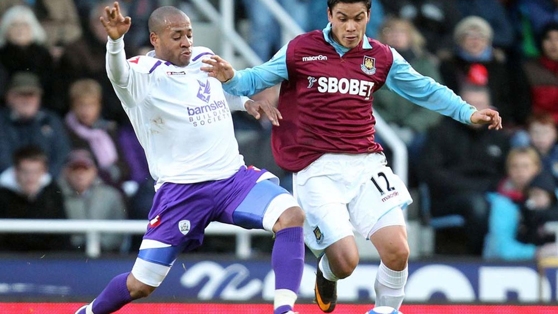 West Ham United's Pablo Barrera, right, controls the ball away from Barnsley's Matt Hill during the English FA Cup third round soccer match at Upton Park, London, Saturday Jan. 8, 2011. West Ham won 2-0. (AP Photo/PA, Matthew Impey) UNITED KINGDOM OUT NO INTERNET/MOBILE USAGE WITHOUT FAPL LICENCE - SEE IPTC SPECIAL INSTRUCTIONS FIELD FOR DETAILS