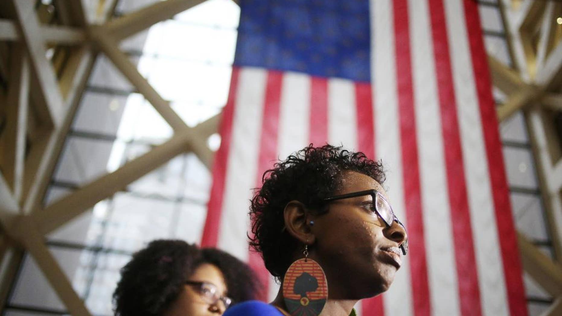 In this Dec. 21, 2015 photo, Kandace Montgomery left and Miski Noor of Black Lives Matter speak with media after a hearing at the Hennepin County Government Center in Minneapolis. A judge ruled Tuesday, Dec. 22, that several local Black Lives Matter organizers cannot demonstrate at the Mall of America on the busy shopping day before Christmas Eve, but she said she couldn’t stop others from attending the protest. (Jerry Holt/Star Tribune via AP) MANDATORY CREDIT; ST. PAUL PIONEER PRESS OUT; MAGS OUT; TWIN CITIES LOCAL TELEVISION OUT