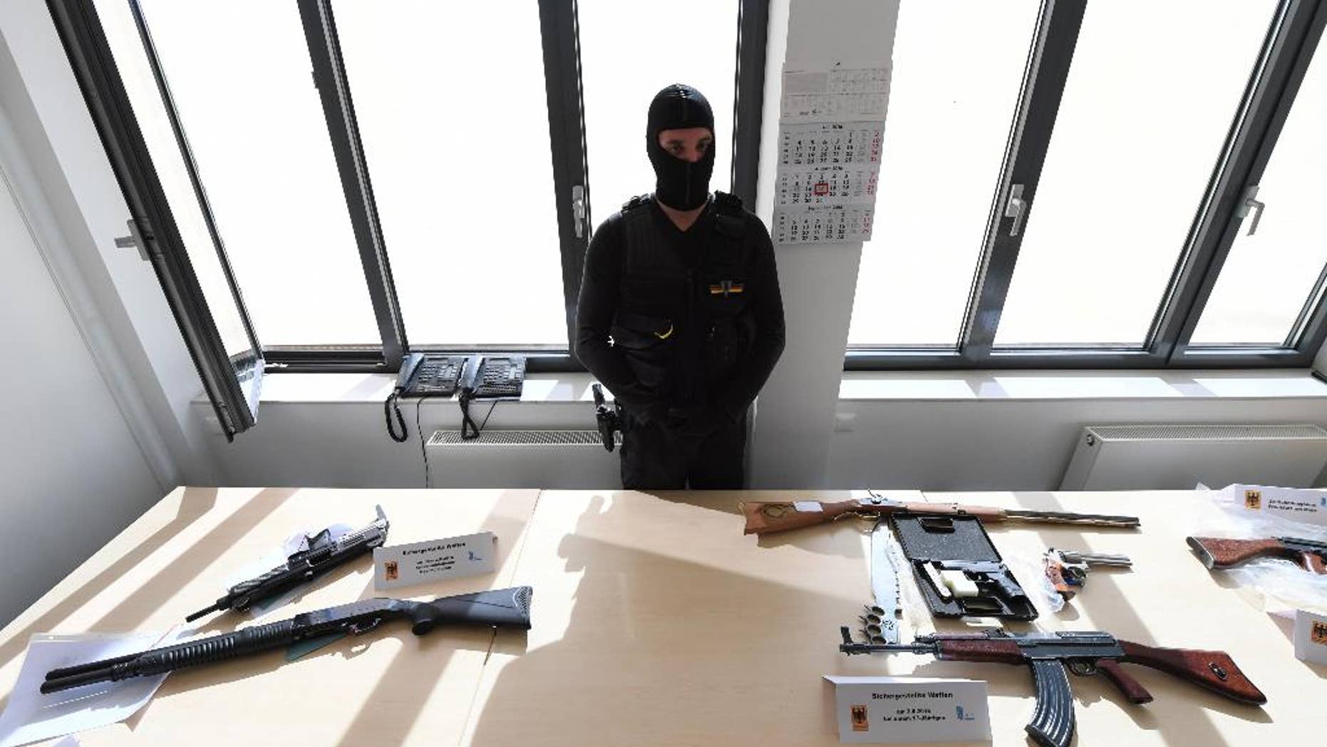 The Customs Office in Frankfurt displays seized firearms at a press conference in Frankfurt, Germany, Wednesday Aug. 17, 2016. German prosecutors say the teenager who went on a shooting rampage at a Munich mall last month, killing nine people and then himself, paid 4,350 euros (nearly $4,900) for his gun and ammunition. Authorities on Tuesday arrested a 31-year-old unemployed salesman accused of selling the Glock 17 pistol to the 18-year-old gunman. That connection surfaced as the suspected dealer was being investigated for other sales. (Arne Dedert/dpa via AP)