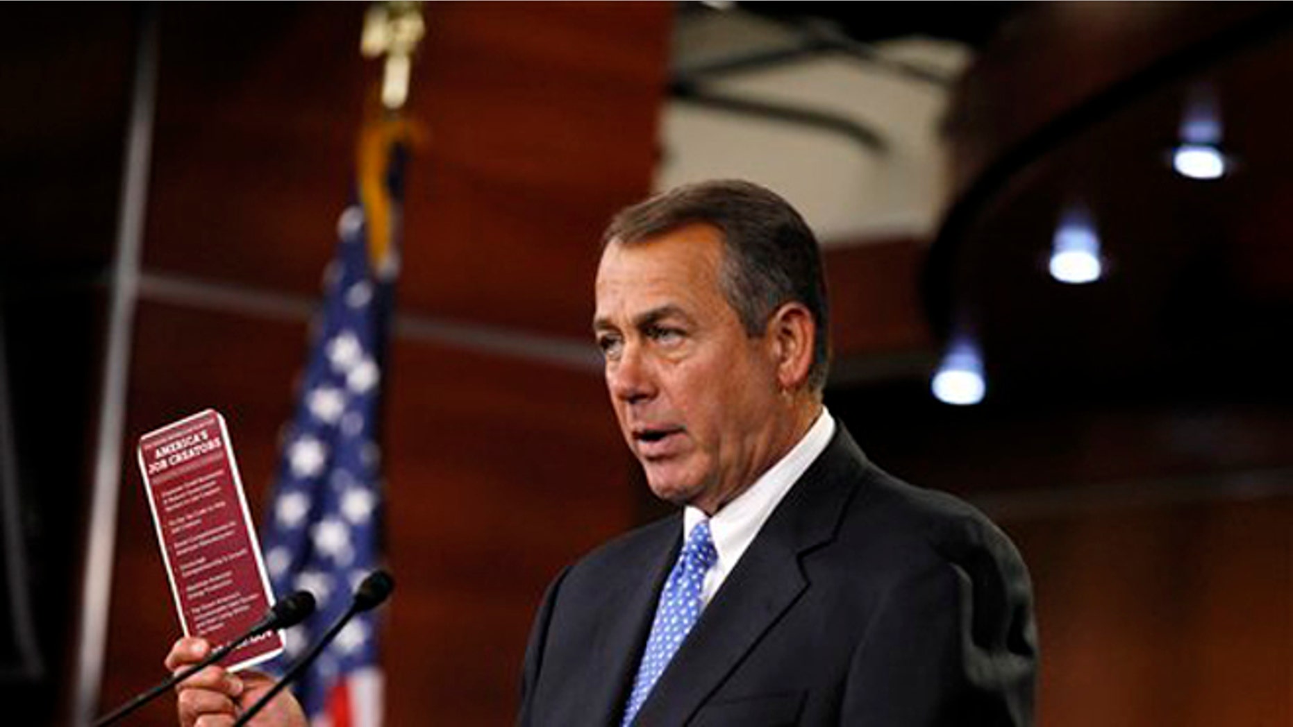 House Speaker John Boehner, R-Ohio, holds a job brochure during a news conference on Capitol Hill in Washington.