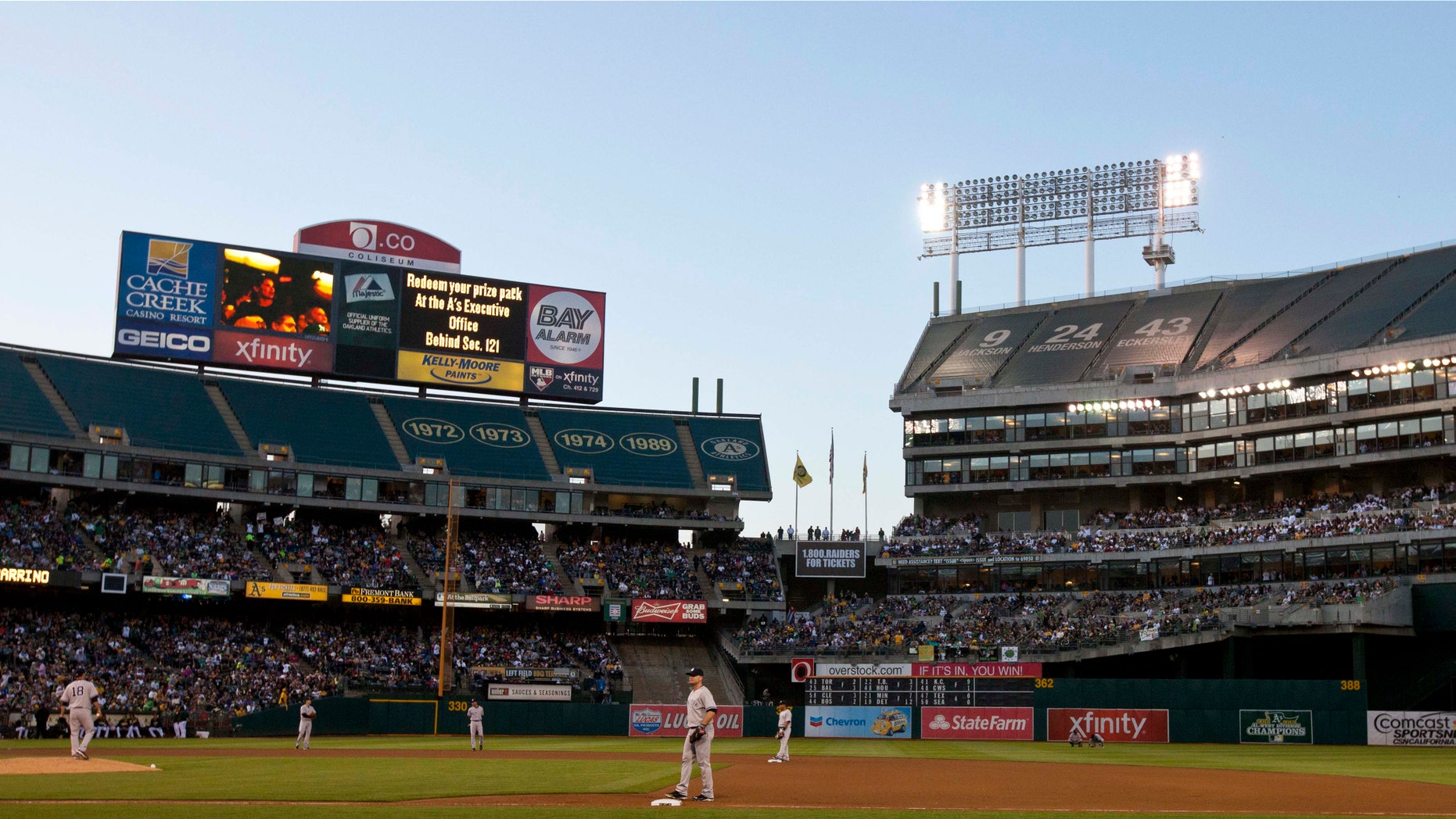 OAKLAND, CA - JUNE 14: Play is suspended during the fourth inning between the Oakland Athletics and the New York Yankees because of faulty stadium lights in left field at O.co Coliseum on June 14, 2014 in Oakland, California. (Photo by Jason O. Watson/Getty Images)