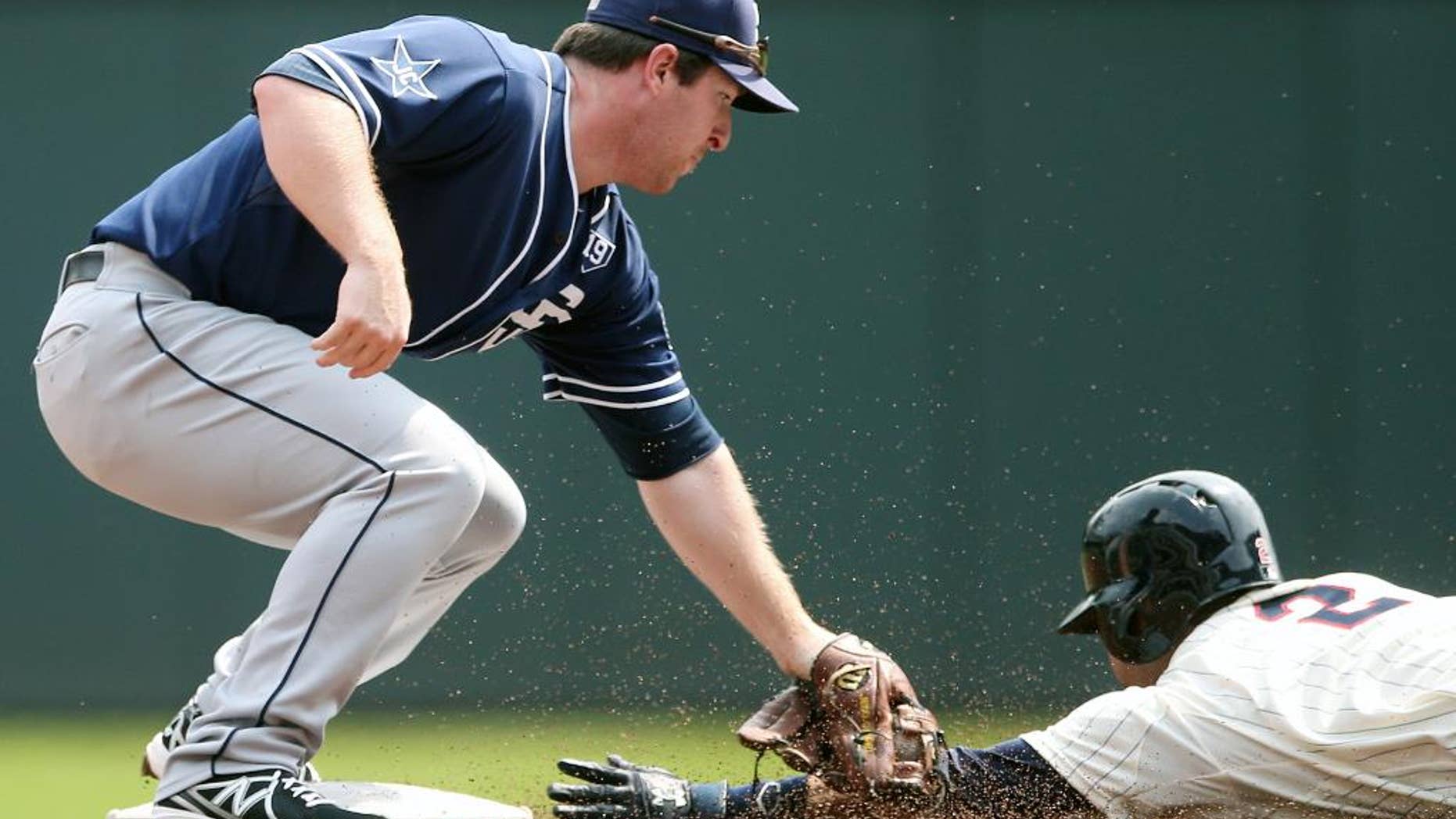San Diego Padres second baseman Jedd Gyorko, left, reaches to tag Minnesota Twins' Brian Dozier who was called safe as he stole second base in the first inning of a baseball game, Wednesday, Aug. 6, 2014, in Minneapolis. (AP Photo/Jim Mone)