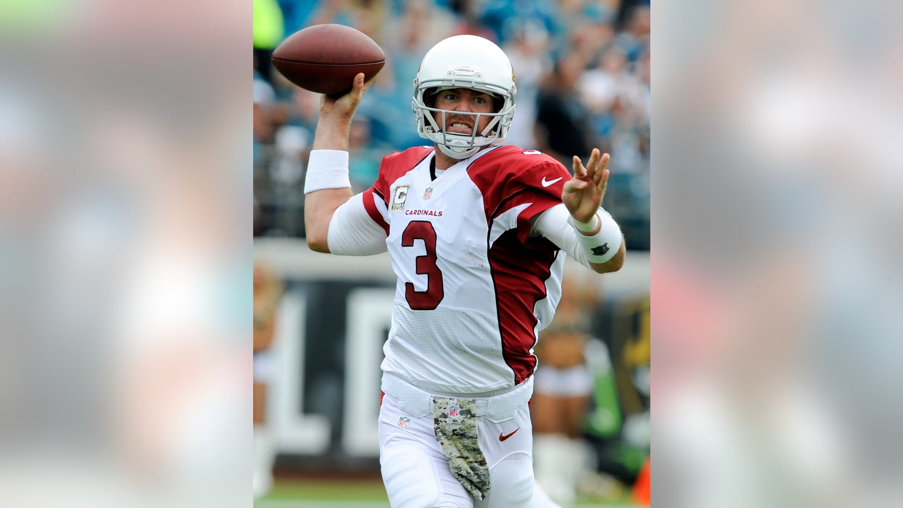 Arizona Cardinals quarterback Carson Palmer (3) throws a pass as he is pressured by the Jacksonville Jaguars defense during the first half of an NFL football game in Jacksonville, Fla., Sunday, Nov. 17, 2013. (AP Photo/Stephen Morton)