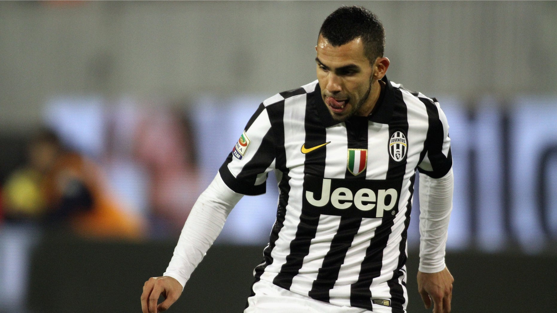 CAGLIARI, ITALY - DECEMBER 18: Carlos Tevez of Juventus in action during the Serie A match betweeen Cagliari Calcio and Juventus FC at Stadio Sant'Elia on December 18, 2014 in Cagliari, Italy. (Photo by Enrico Locci/Getty Images)