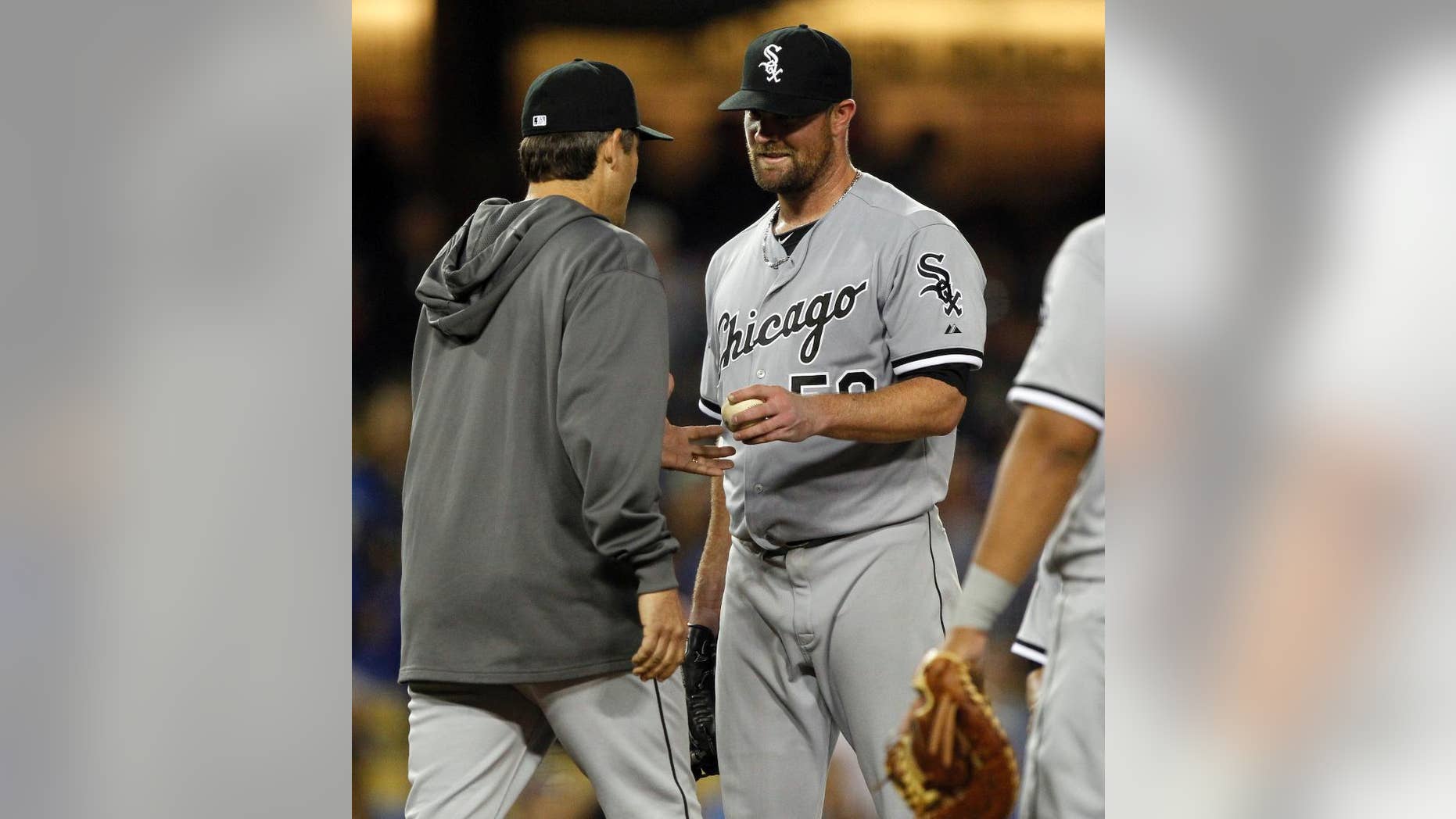 Chicago White Sox manager Robin Ventura, left, pulls starting pitcher John Danks, right, in the eighth inning of a baseball game against the Los Angeles Dodgers on Wednesday, June 4, 2014 in Los Angeles. (AP Photo/Alex Gallardo)