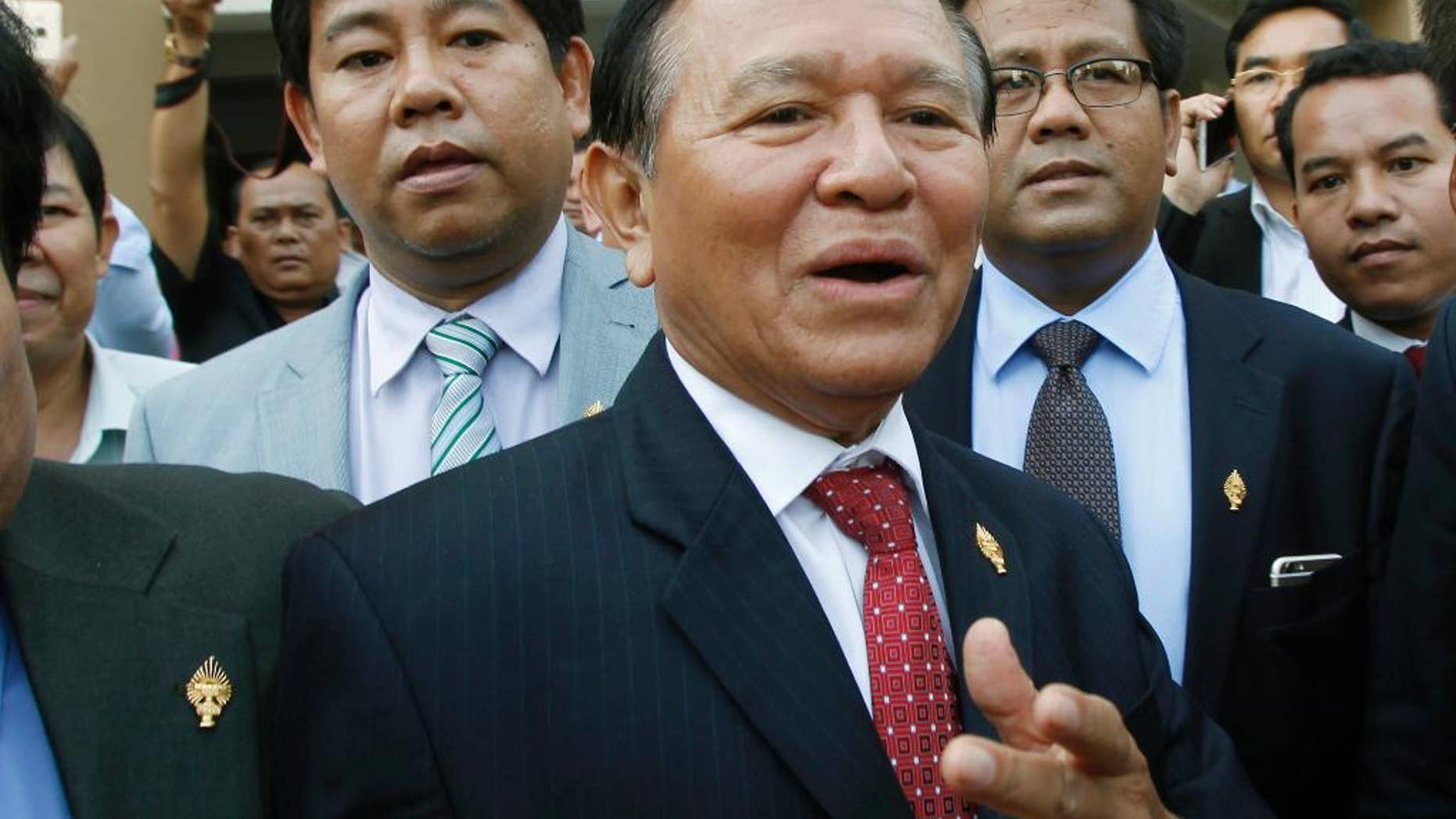 In this April 8, 2015 photo, Cambodia's main opposition Cambodia National Rescue Party Deputy President and National Assembly Deputy President Kem Sokha, center, speaks to the media outside the Phnom Penh Municipality Court in Phnom Penh, Cambodia. The senior leader of Cambodia’s opposition party was stripped of his post as the vice-president of parliament in a skewed and unexpected vote Friday, Oct. 30, 2015 that was attended only by the ruling party. (AP Photo/Heng Sinith)