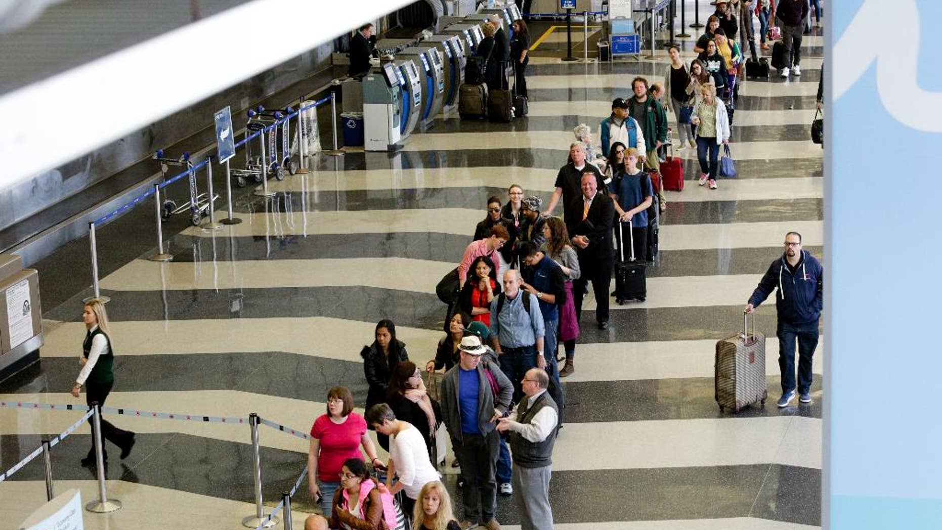 File-This May 16, 2016, file photo shows a long line of travelers waiting for the TSA security check point at O'Hare International airport, in Chicago. As airport security lines get longer, the finger-pointing over blame is growing too. The nation's leading airlines, already feuding with the Transportation Security Administration, are now taking on Congress. The trade group Airlines for America on Thursday, May 19, 2016, says Congress should reverse a 2013 decision that diverted $12.6 billion in passenger-security fees to reducing the federal budget deficit. The airlines want that money to pay for airport security screening. (AP Photo/Teresa Crawford)