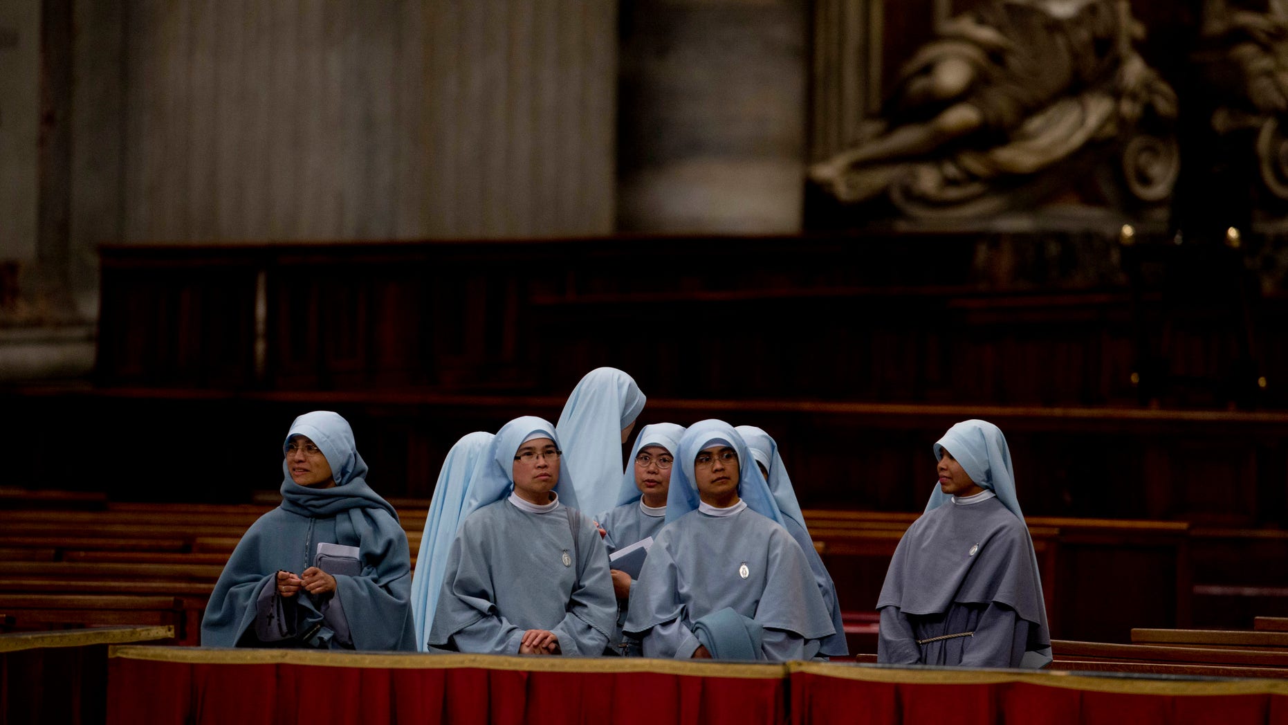 Nuns wait for the arrival of Pope Francis for a ceremony to bless a mosaic dedicated to Filipino St. Pedro Calungsod, in St. Peter's Basilica at the Vatican, Thursday, Nov. 21, 2013. (AP Photo/Andrew Medichini)