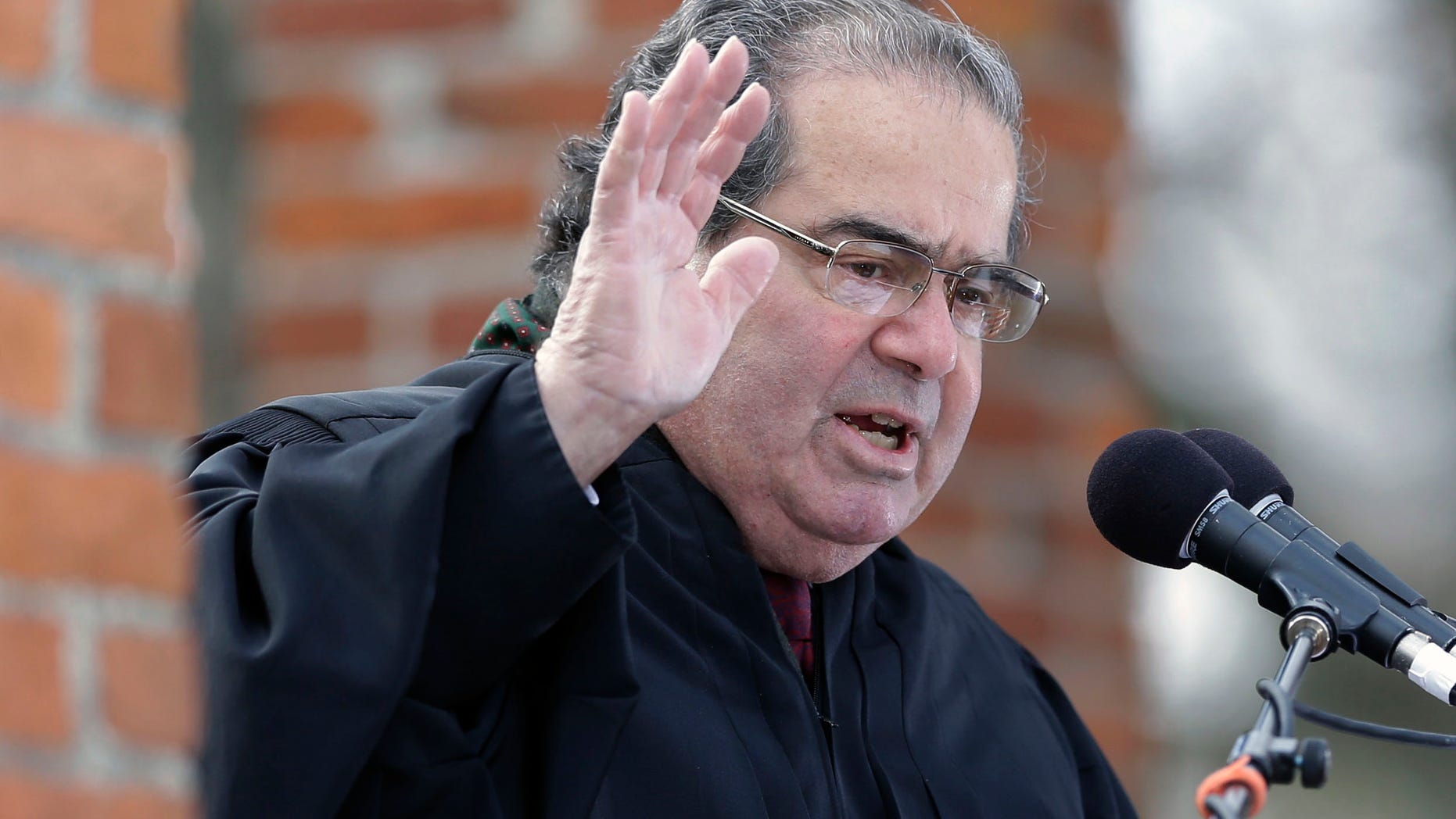 Supreme Court Justice Antonin Scalia administers the oath of allegiance to new citizens, during a ceremony commemorating the 150th anniversary of the dedication of the Soldiers’ National Cemetery and President Abraham Lincoln's Gettysburg Address, Tuesday, Nov. 19, 2013, in Gettysburg, Pa. Lincoln's speech was first delivered in Gettysburg nearly five months after the major battle that left tens of thousands of men wounded, dead or missing. (AP Photo/Matt Rourke)