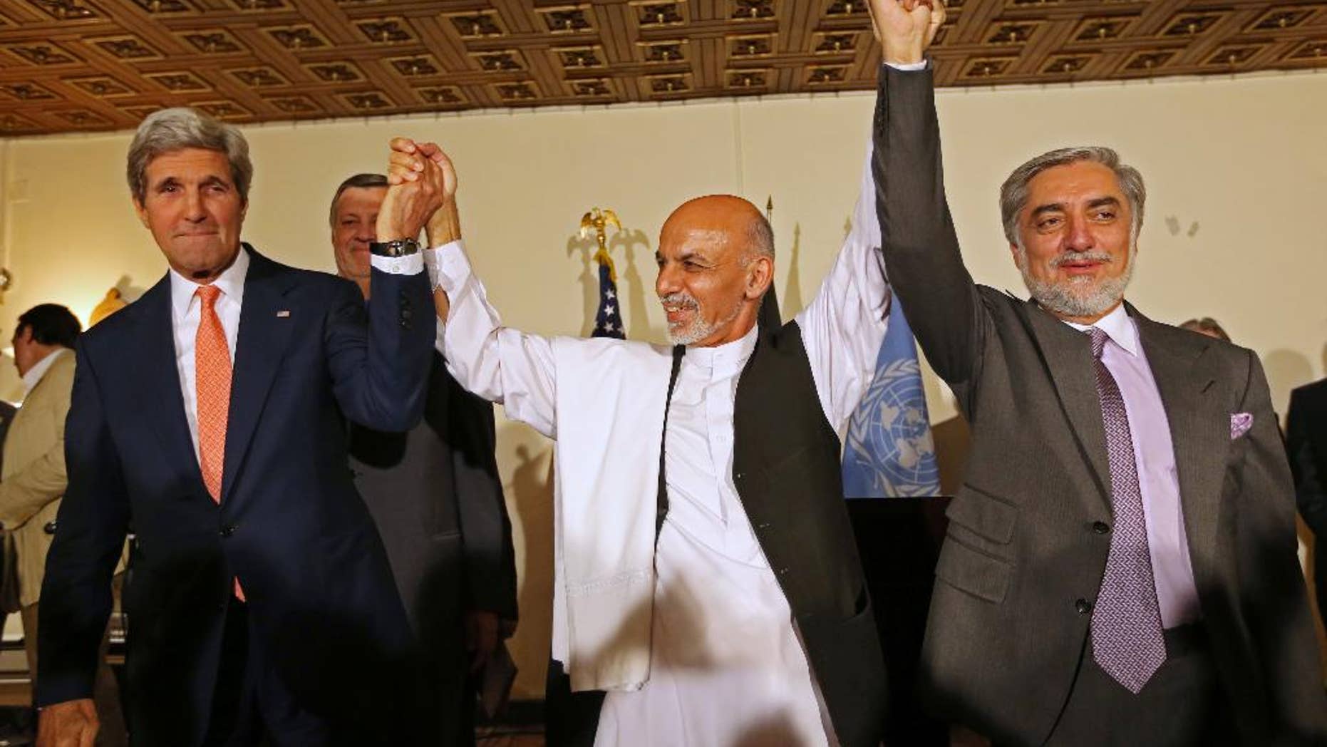 FILE - This July 12, 2014 file photo shows. from left, Secretary of State John Kerry, Afghanistan's presidential candidate Ashraf Ghani Ahmadzai, and Afghan presidential candidate Abdullah Abdullah during a joint news conference in Kabul, Afghanistan. The Obama administration on Thursday stepped up efforts to press Afghanistan’s two feuding presidential candidates to end their dispute over June elections, accept the results of an ongoing audit of all ballots and form a national unity government by early September. On an unannounced visit to Kabul, Kerry made personal appeals to both candidates _ former Foreign Minister Abdullah Abdullah and former Finance Minister Ashraf Ghani Ahmadzai _ to understand the urgency of finding a resolution before the upcoming NATO summit in Wales on September 4, according to officials traveling with Kerry. (AP Photo/Rahmat Gul, File)