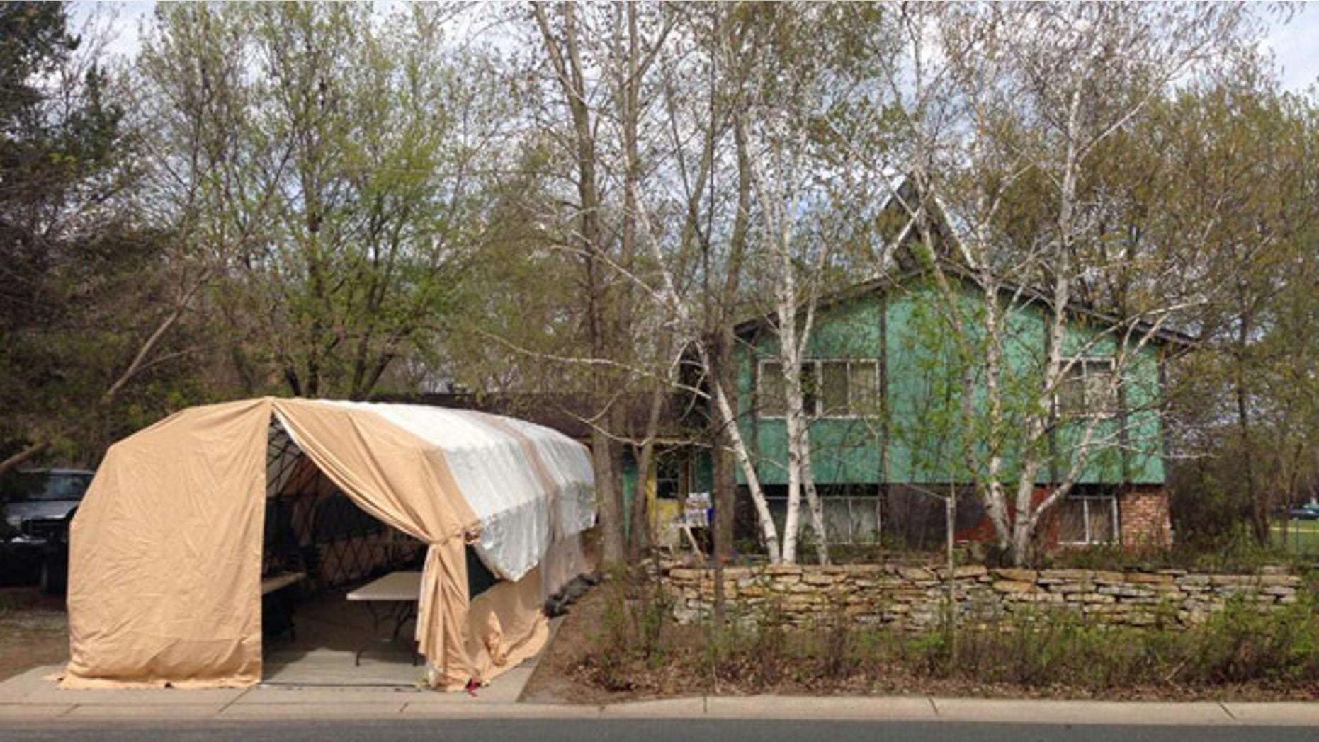 May 18, 2014: A tent set up by investigators outside the Maple Grove, Minn. home of Amy Pagnac, who disappeared in 1989. (Iris Perez/MyFoxTwinCities.com)