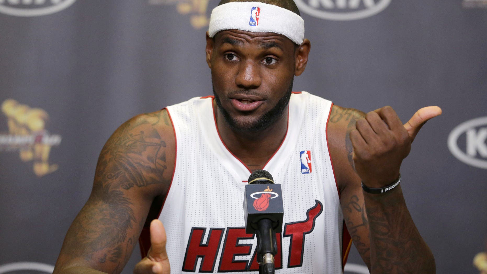 Miami Heat forward LeBron James gestures as he answers questions at a news conference during NBA basketball media day, Monday, Sept. 30, 2013 in Miami. (AP Photo/Wilfredo Lee)