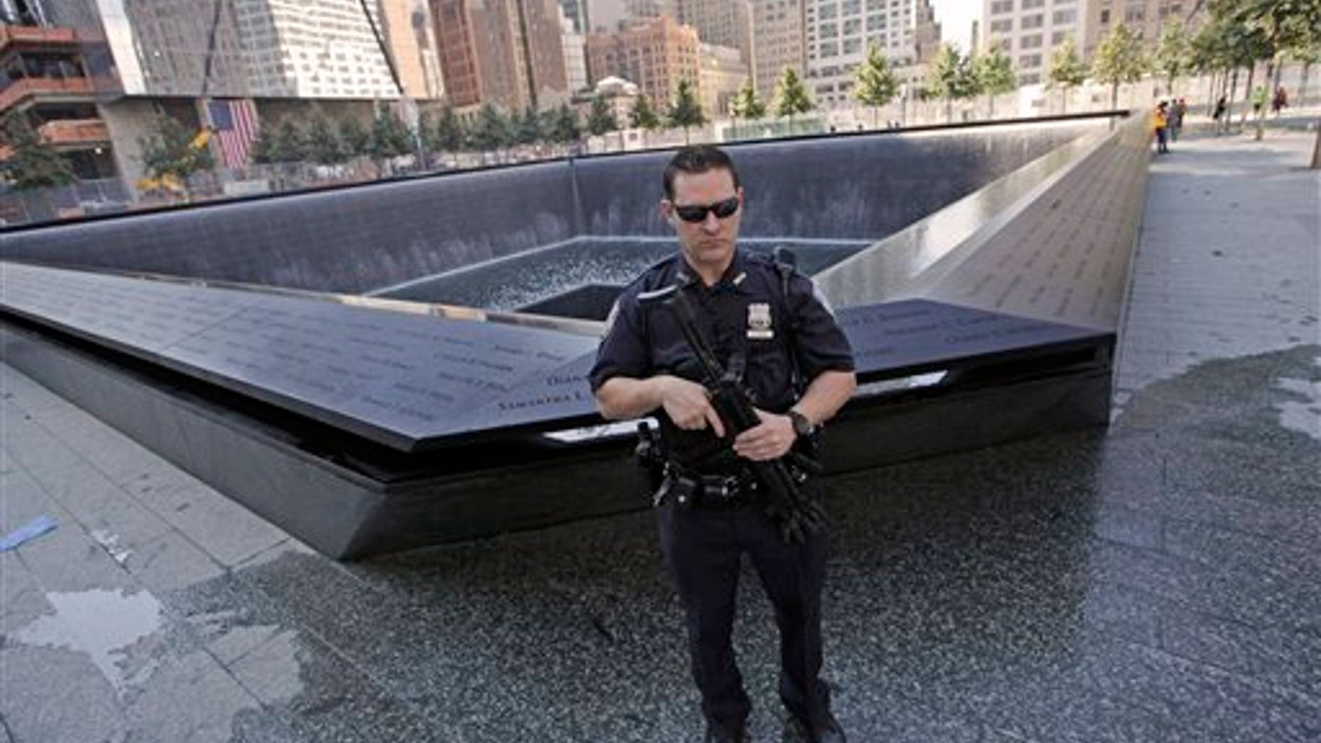 Sept. 9: A heavily armed Port Authority police officer stand guard next to the North Pool at the World Trade Center memorial site Friday, in New York. Just days before the 10th anniversary of the Sept. 11 attacks, U.S. counterterrorism officials are chasing a credible but unconfirmed al-Qaida threat to use a car bomb on bridges or tunnels in New York City or Washington.