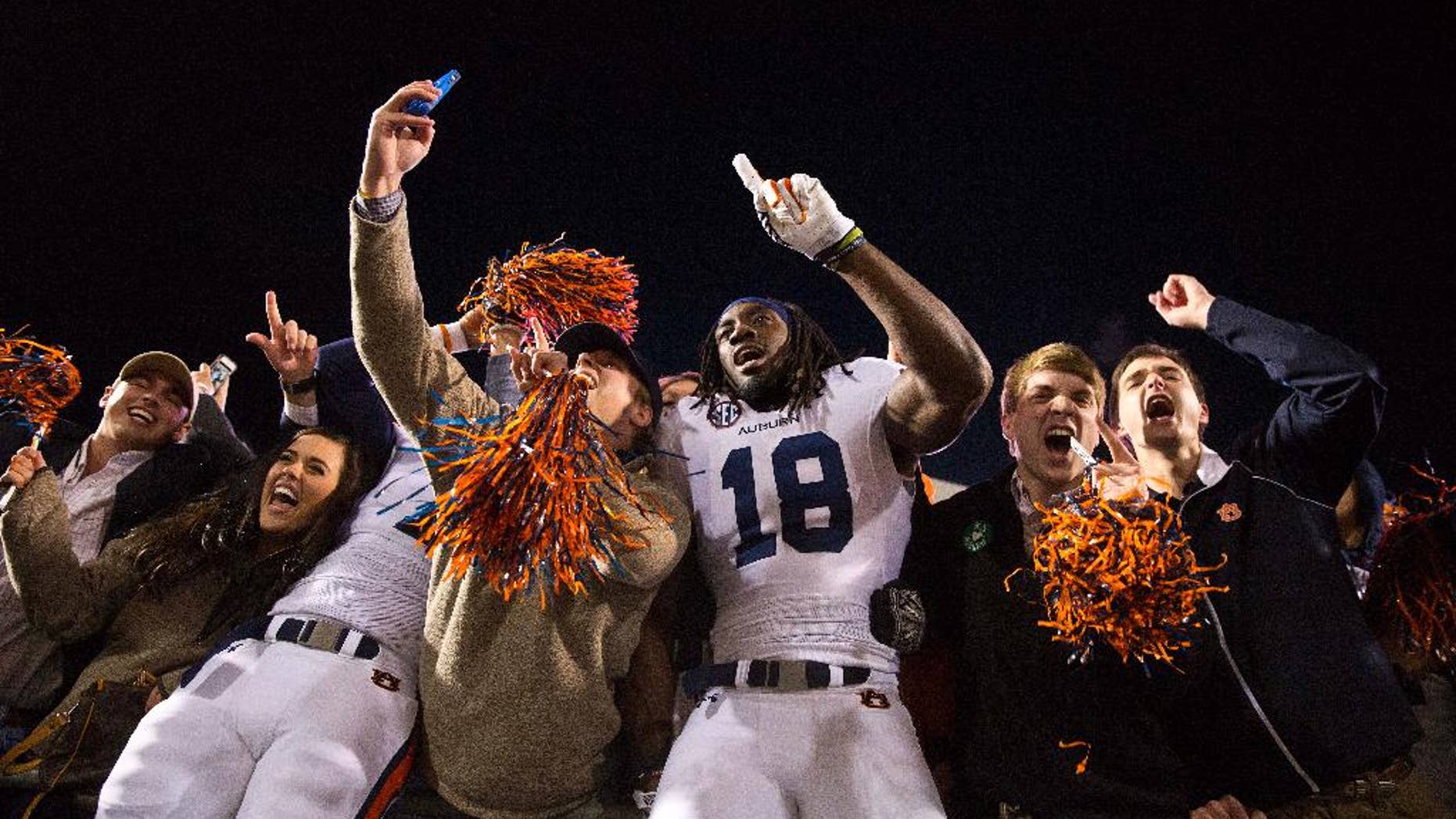 Auburn wide receiver Sammie Coates (18) celebrates with Auburn fans after a victory over Mississippi in an NCAA college football game, Saturday, Nov. 1, 2014, in Oxford, Miss. Auburn won 35-31. (AP Photo/Brynn Anderson)
