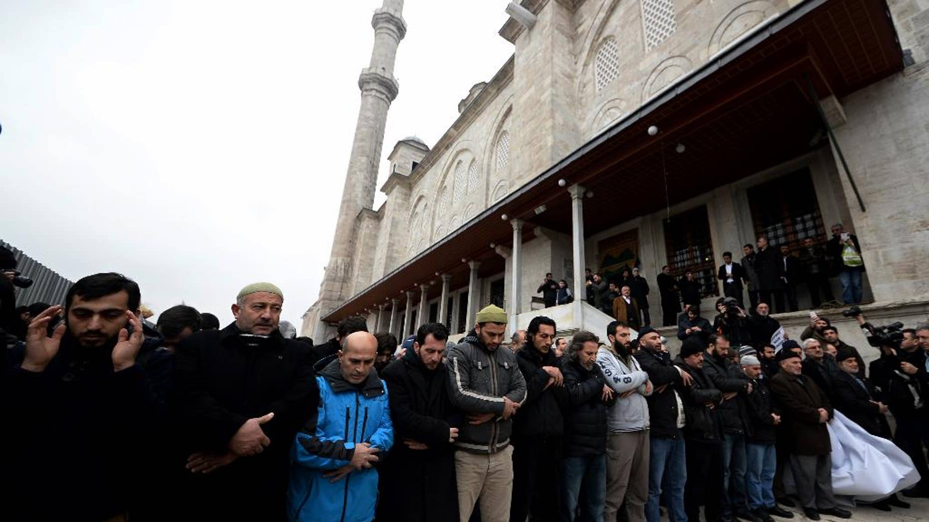 Members of pro-Islamic groups shout slogans after they held funeral prayers on Friday to honor Cherif and Said Kouachi, the gun-toting brothers who killed 12 people last week in Paris, in Istanbul, Turkey, Friday, Jan. 16, 2015. Some 160 people — all of them men — shouted "God is great!" and they held a banner showing former al-Qaida leader Osama Bin Laden's picture on one side, and the Kouachi brothers superimposed over the Parisian skyline on the other. Smaller posters with "We are all Cherif" and "We are all Said" were bounced up. (AP Photo)