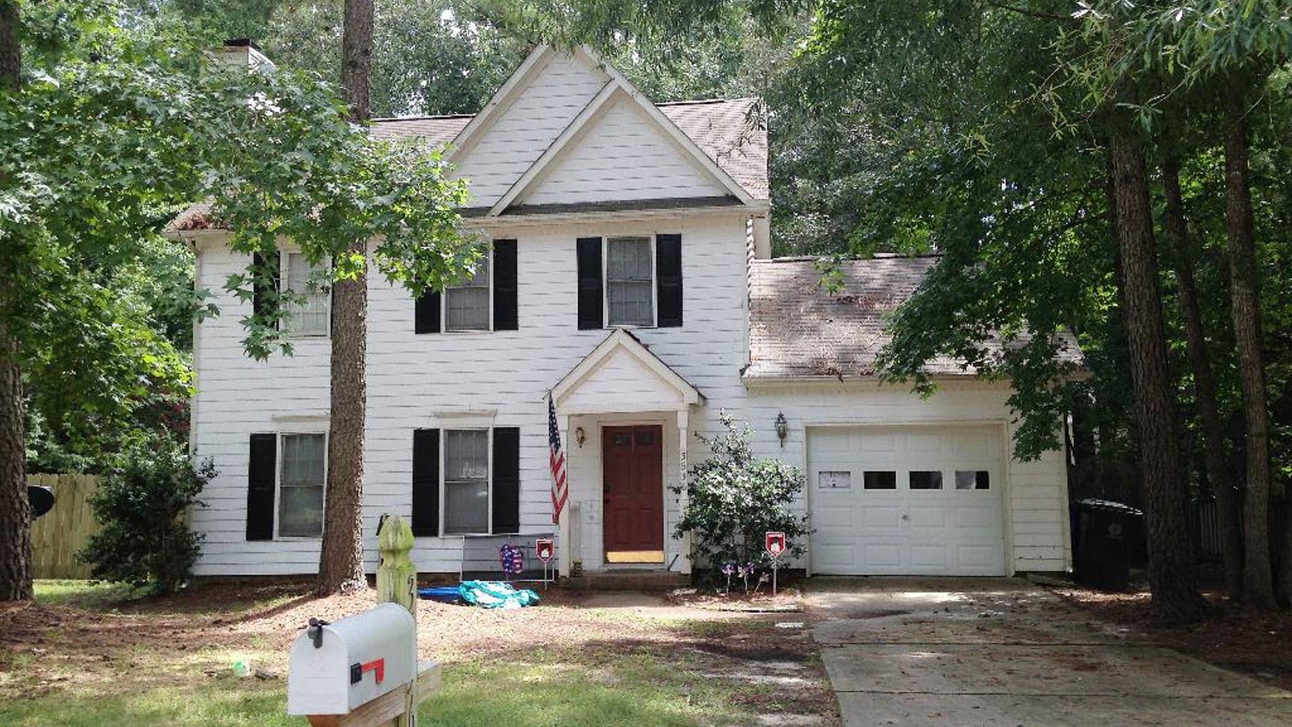 The home of Raleigh shooting suspect 39-year-old Chad Cameron Copley is seen Tuesday, Aug. 9, 2016, in Raleigh, N.C. Police say Copley fired a shotgun from inside his garage and fatally struck a 20-year-old black man. Witnesses say the body lay close to a mailbox. (AP Photo/Jonathan Drew)