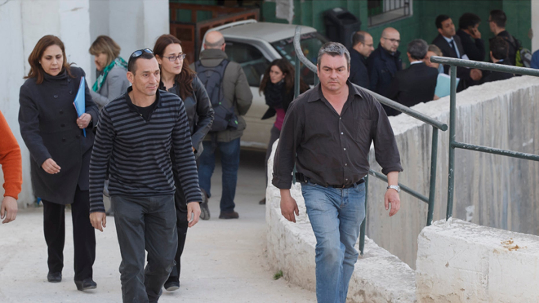 Unidentified Spanish relatives of victims of the Tunis attack leave the morgue of the Charles Nicolle hospital in Tunis Tunisia, Thursday, March 19, 2015. The radical Islamic State Group claimed responsibility Thursday for the attack on a famed Tunis museum that left 23 people dead. (AP Photo/Michel Euler)