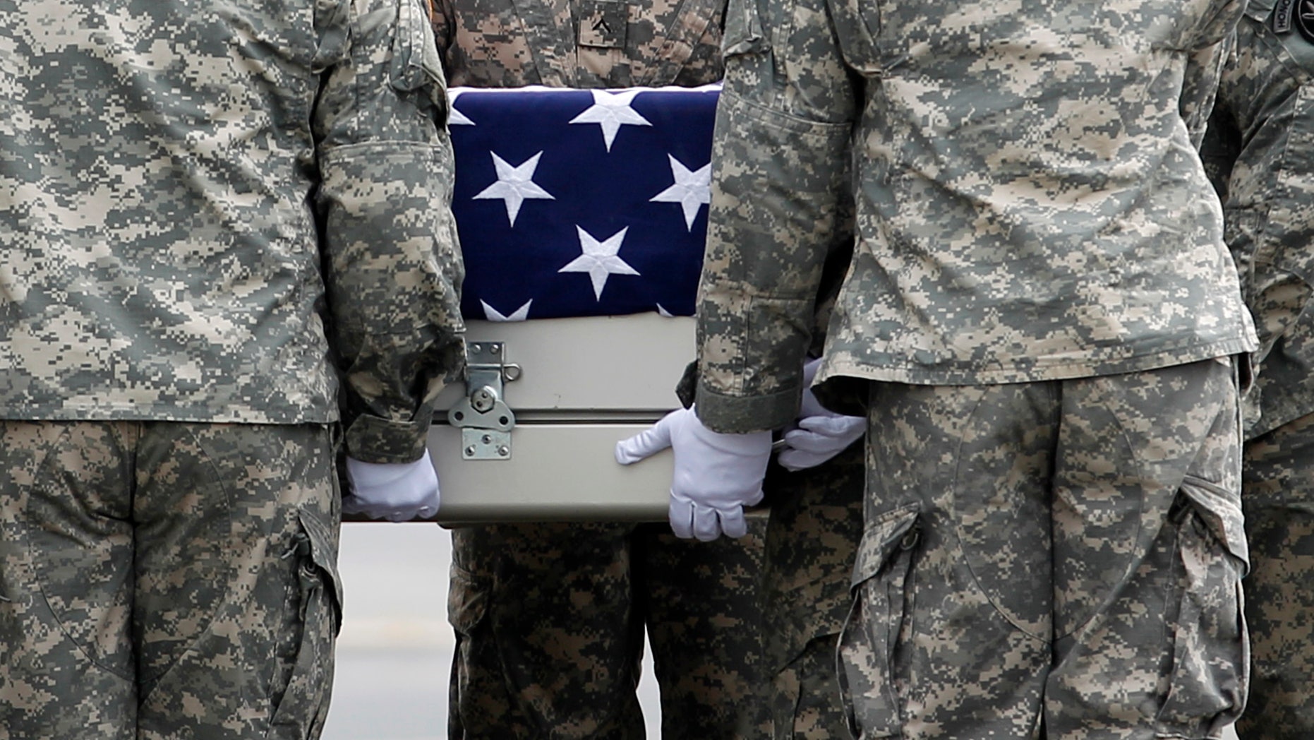 An Army carry team carries the transfer case containing the remains of Army Staff Sgt. Michael J. García of Bossier City, La. upon arrival at Dover Air Force Base, Del. on Wednesday, July 6, 2011. The Department of Defense announced the death of García who was supporting Operation Enduring Freedom in Afghanistan.(AP Photo/José Luis Magaña)