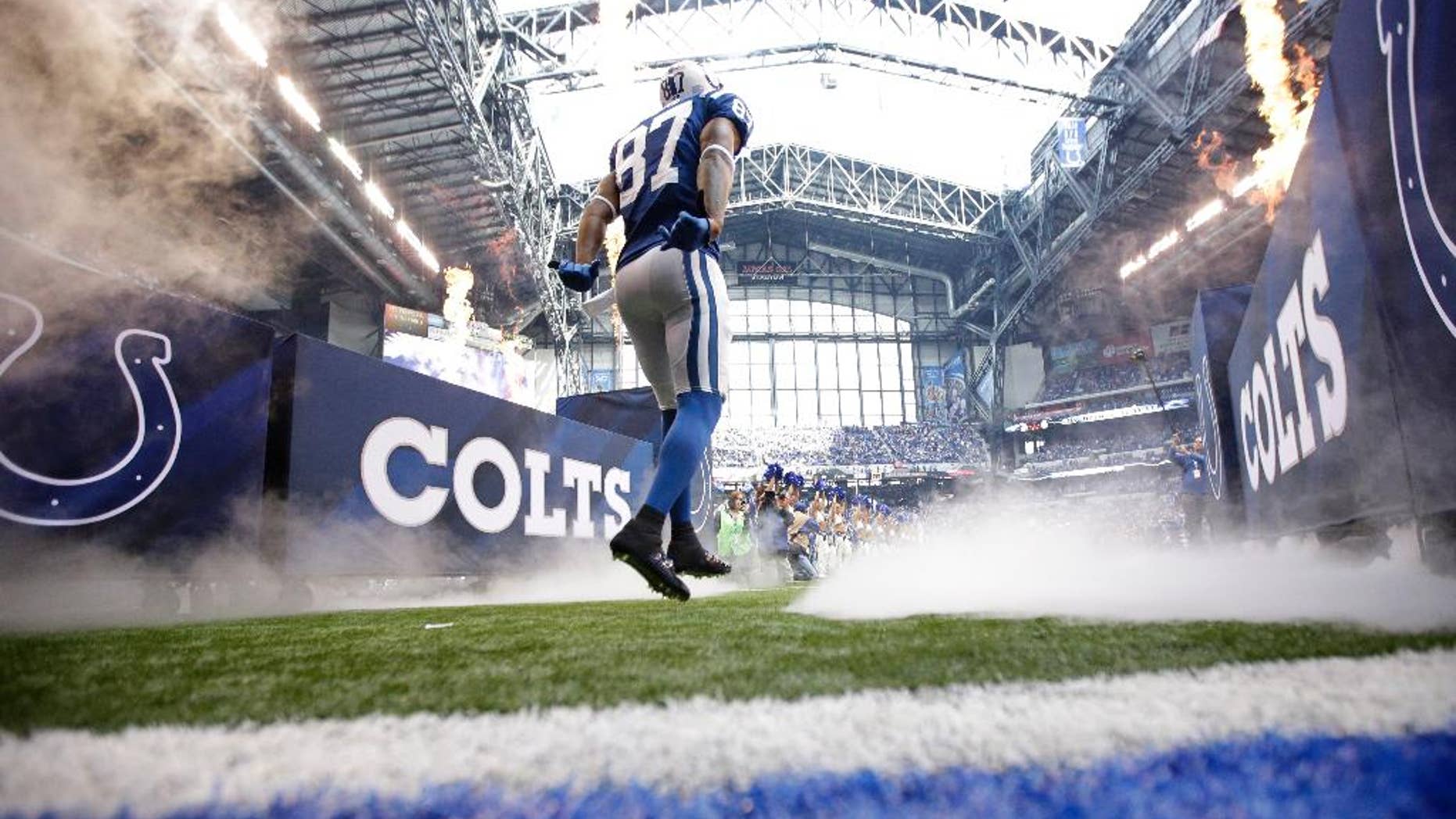 Indianapolis Colts wide receiver Reggie Wayne runs onto the field after being introduced before an NFL football game against the Cincinnati Bengals, Sunday, Oct. 19, 2014, in Indianapolis. (AP Photo/AJ Mast)