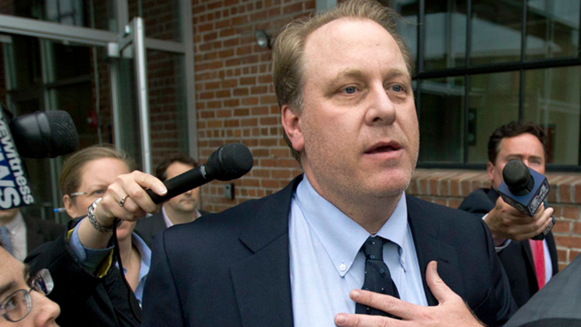 In this Wednesday, May 16, 2012, file photo, former Boston Red Sox pitcher Curt Schilling, center, is followed by members of the media as he departs the Rhode Island Economic Development Corporation headquarters, in Providence, R.I.
