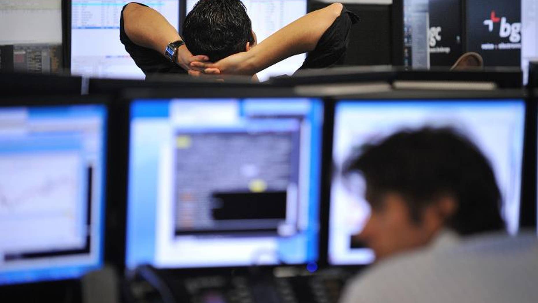 Brokers monitor market movements at the BGC Partners firm in London on August 5, 2011