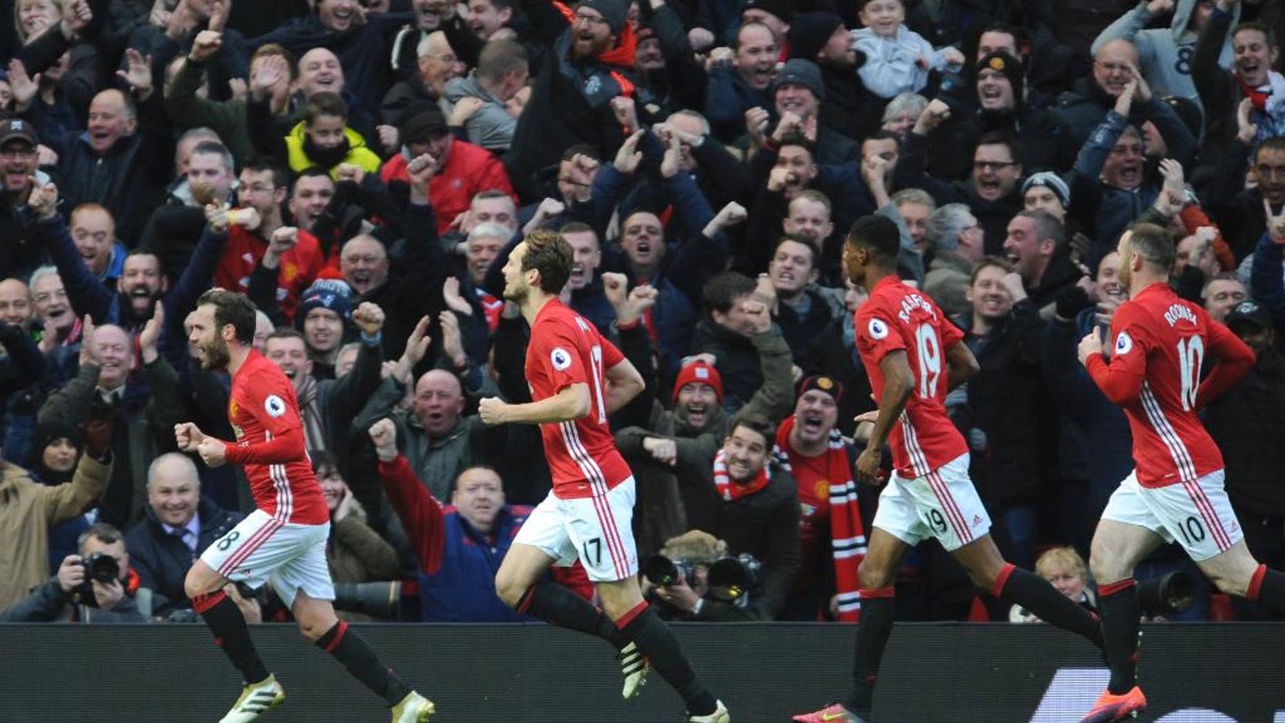 Manchester United's Juan Mata, left, leads celebrations after scoring against Arsenal during the English Premier League soccer match between Manchester United and Arsenal at Old Trafford in Manchester, England, Saturday, Nov. 19, 2016. (AP Photo/Rui Vieira)