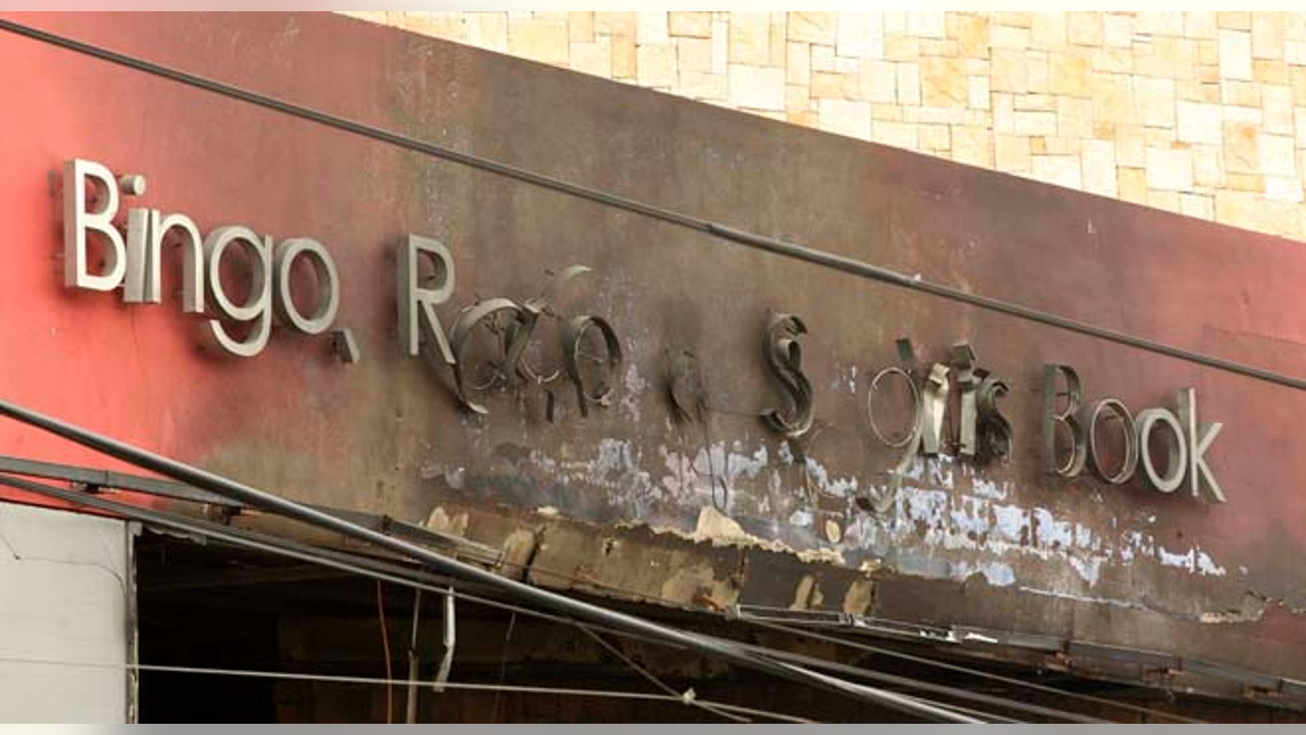 The Casino Royale sign that once read "Bingo, Race & Sports Book" is charred from the deadly arson assault in Monterrey, Mexico, Friday Aug. 26, 2011. Mexican officials say a group of at least eight assailants poured gasoline inside the casino on Thursday, trapping dozens of people inside and killing at least 52 people. Mexico's President Felipe Calderon declared three days of mourning Friday for the 52 victims of the casino fire set by presumed drug traffickers, branding the attackers "true terrorists" and ordering authorities to offer a $2.4 million reward for their capture. (AP Photo/Hans-Maximo Musielik)