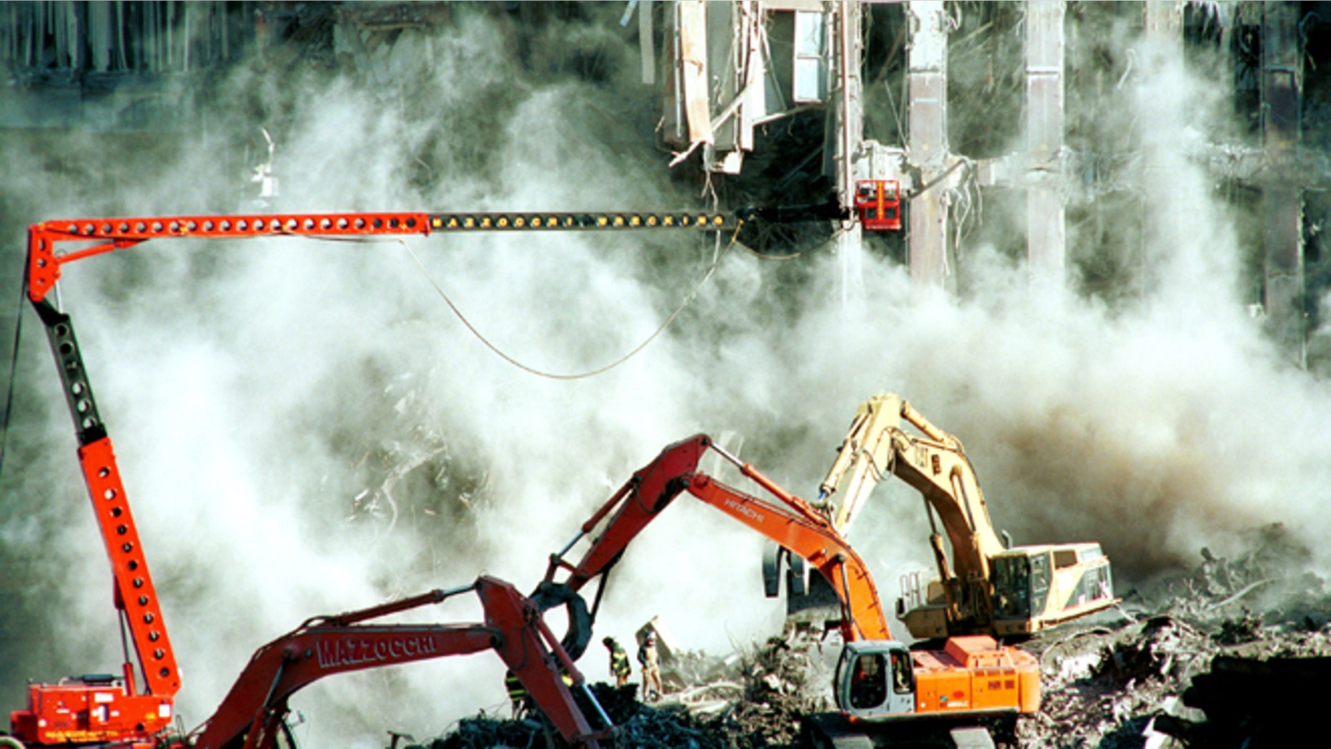396041 01: Weeks after the World Trade Center attacks, firefighters keep clearing the rubble October 17, 2001 in New York. A section of the facade from the south tower of the World Trade Center was brought down with a cloud of dust Tuesday as cleanup of the disaster site entered its sixth week. (Photo by Shaul Schwarz/Getty Images)