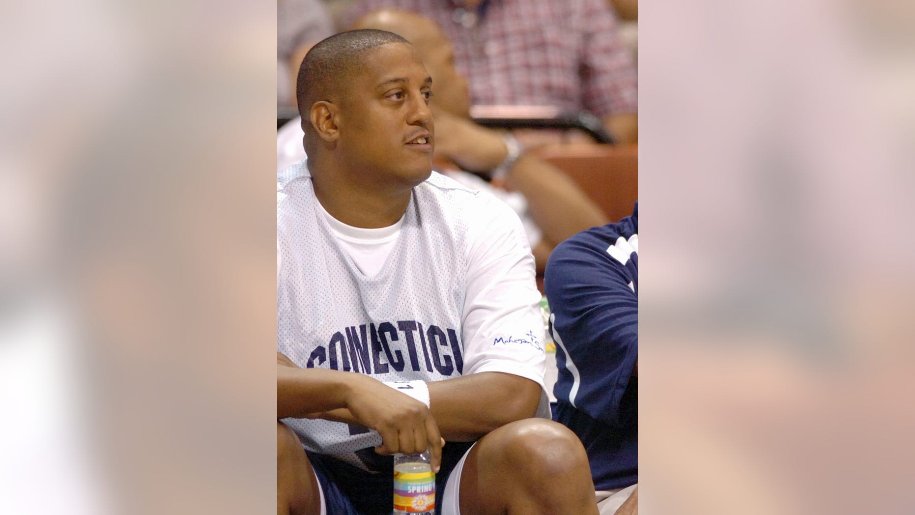 FILE - This Aug. 8, 2008, file photo shows former NBA and University of Connecticut player Tate George during the Jim Calhoun Celebrity Classic basketball game at the Mohegan Sun Arena in Uncasville, Conn. George, a former NBA player convicted of running a real estate Ponzi scheme returns to court to find out his sentence, Tuesday, Dec. 29, 2015. (AP Photo/Fred Beckham, File)