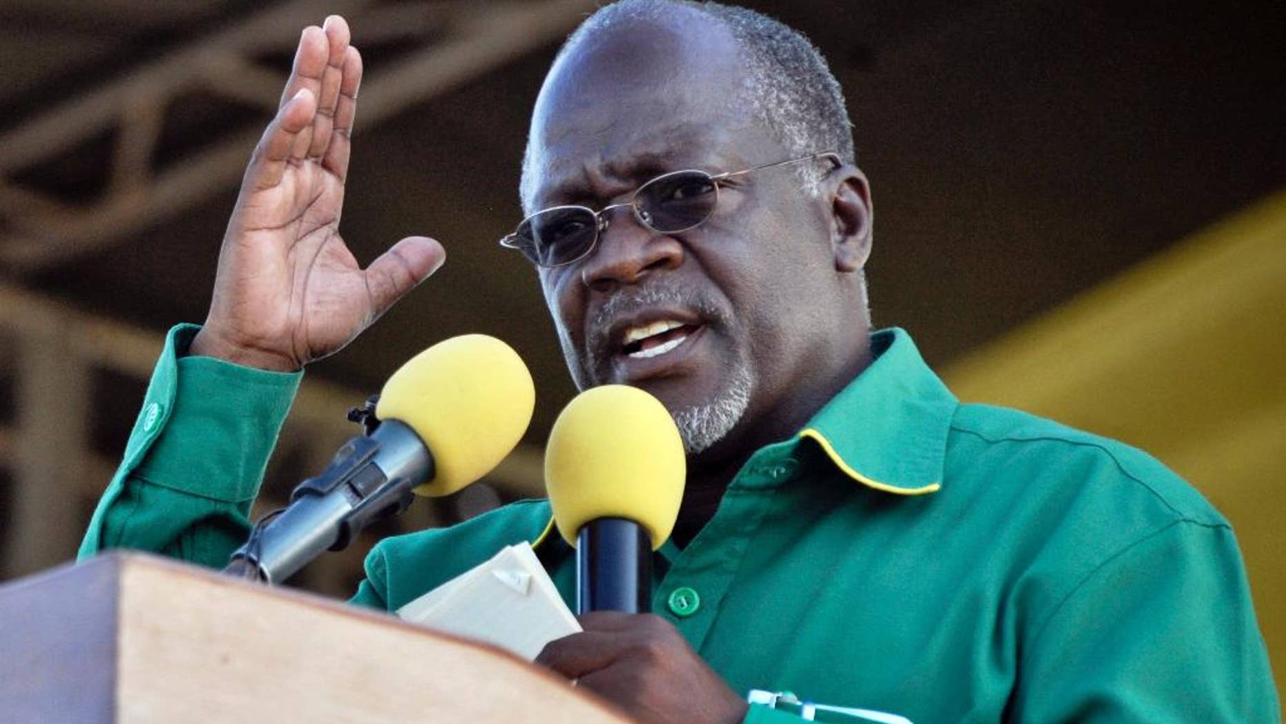 FILE In this Friday Oct.23, 2015 file photo, President John Pombe Magufu gestures, during a rally in Dar es Salaam, Tanzania. At first the new president of Tanzania appeared keen on smashing corruption and wasteful government spending, capturing the imagination of many with austerity measures such as the prohibition of unnecessary official trips abroad. Then came Magufuli's more startling decrees. He banned all opposition rallies until 2020, when the next election is due. He approved a tough new cybercrime law under which some Tanzanians have been charged with insulting him in WhatsApp chats. (AP Photo/Khalfan Said, File)