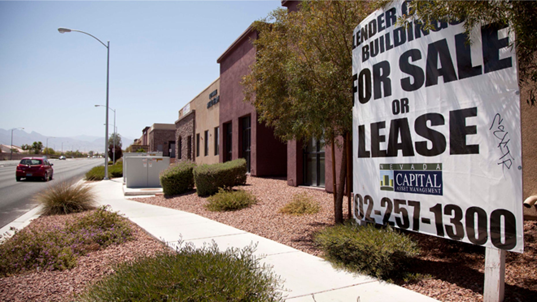 June 21, 2012: A sign advertising empty professional office space for sale or lease is posted outside a building in North Las Vegas, Nev.