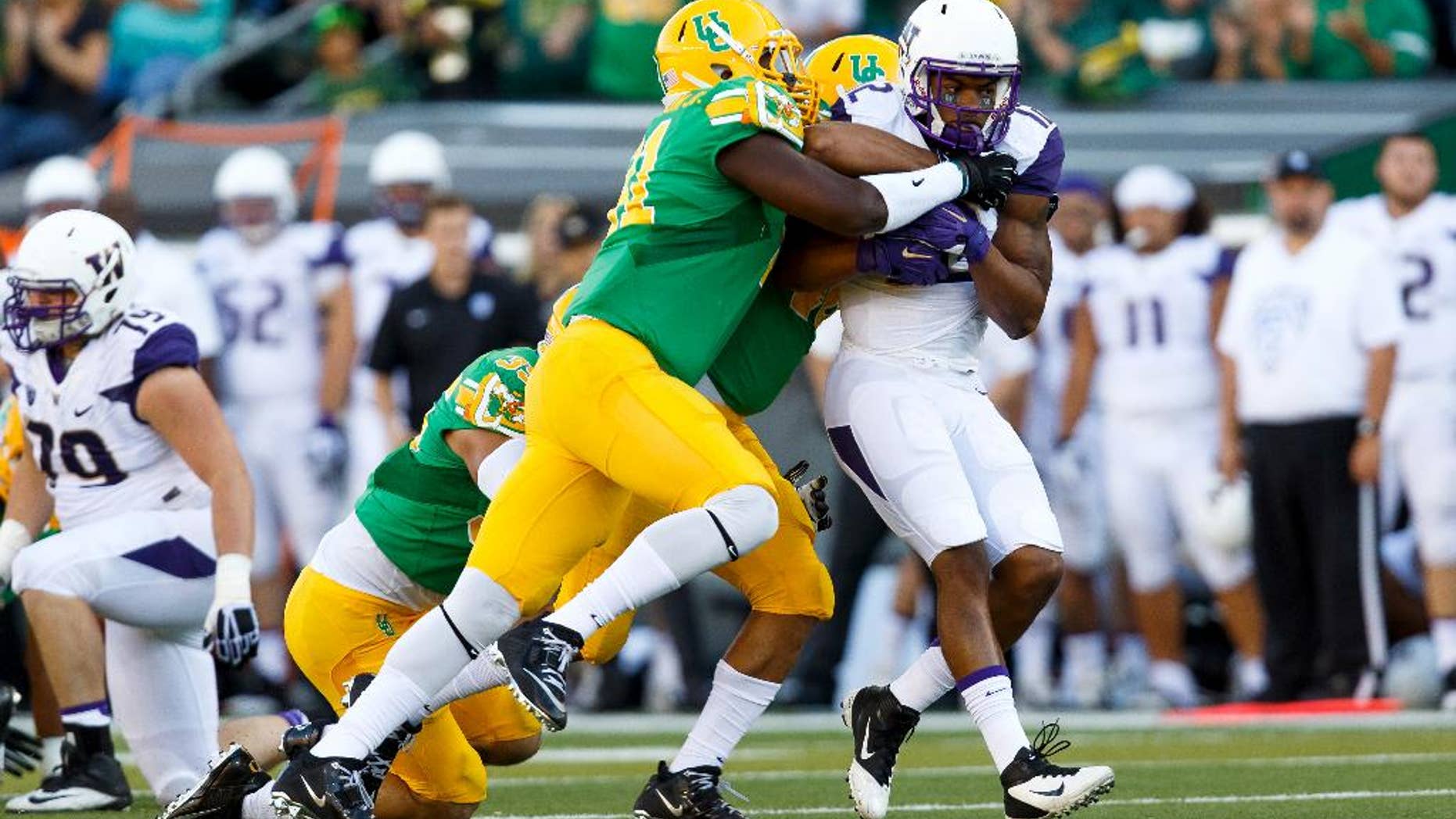 Oregon linebacker Tony Washington (91) stops Washington running back Dwayne Washington (12) during the first quarter in an NCAA college football game in Eugene, Ore., Saturday, Oct. 18, 2014. (AP Photo/Ryan Kang)