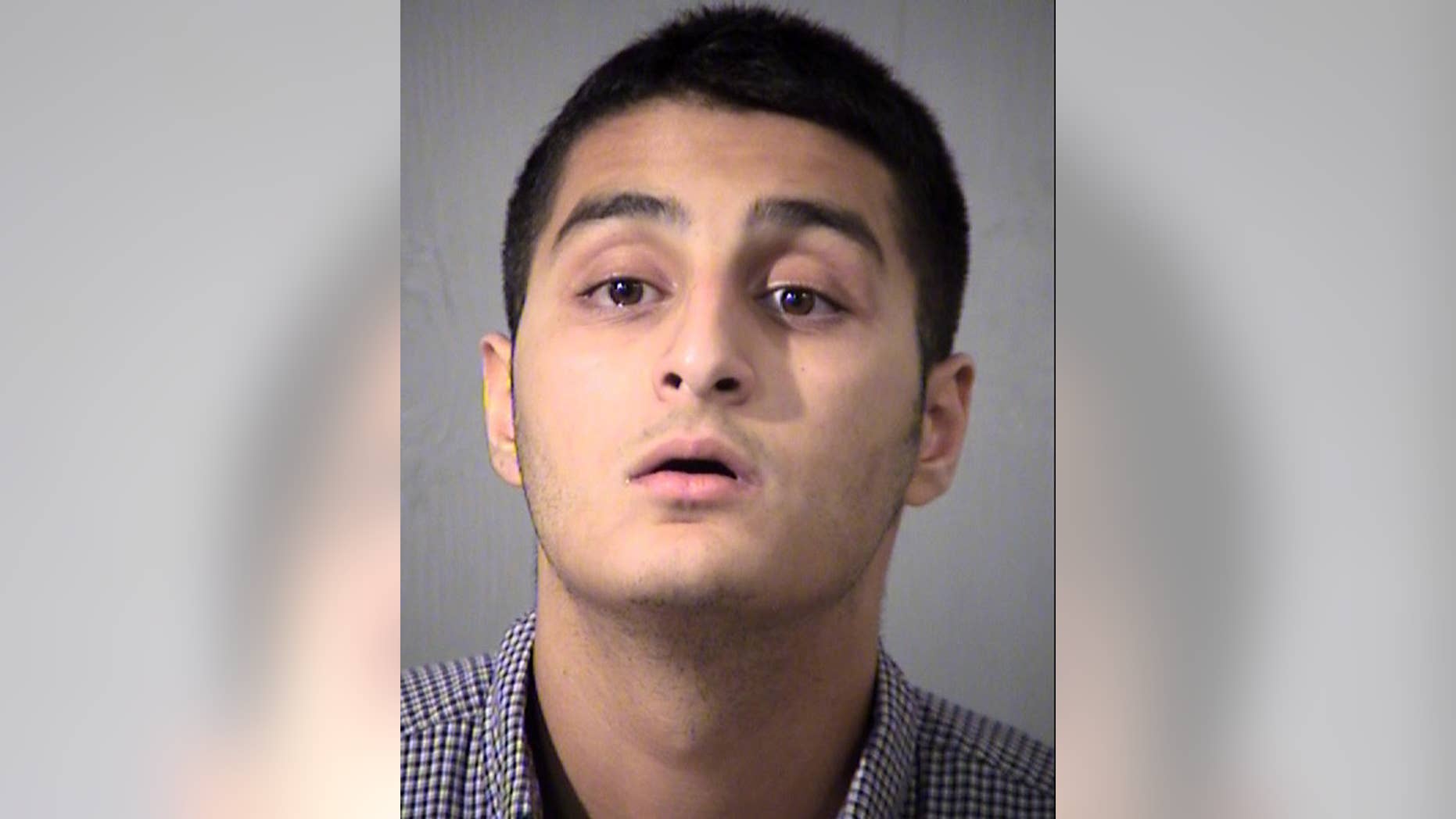 This mugshot taken Friday, July 1, 2016 and provided by the Maricopa County Sheriff's Office shows Mahin Khan, of Tucson, Ariz. Khan has been arrested by the FBI and the Arizona Attorney General's Office for threatening to commit acts of terrorism on government buildings in Tucson and Phoenix. (Maricopa County Sheriff's Office via AP)