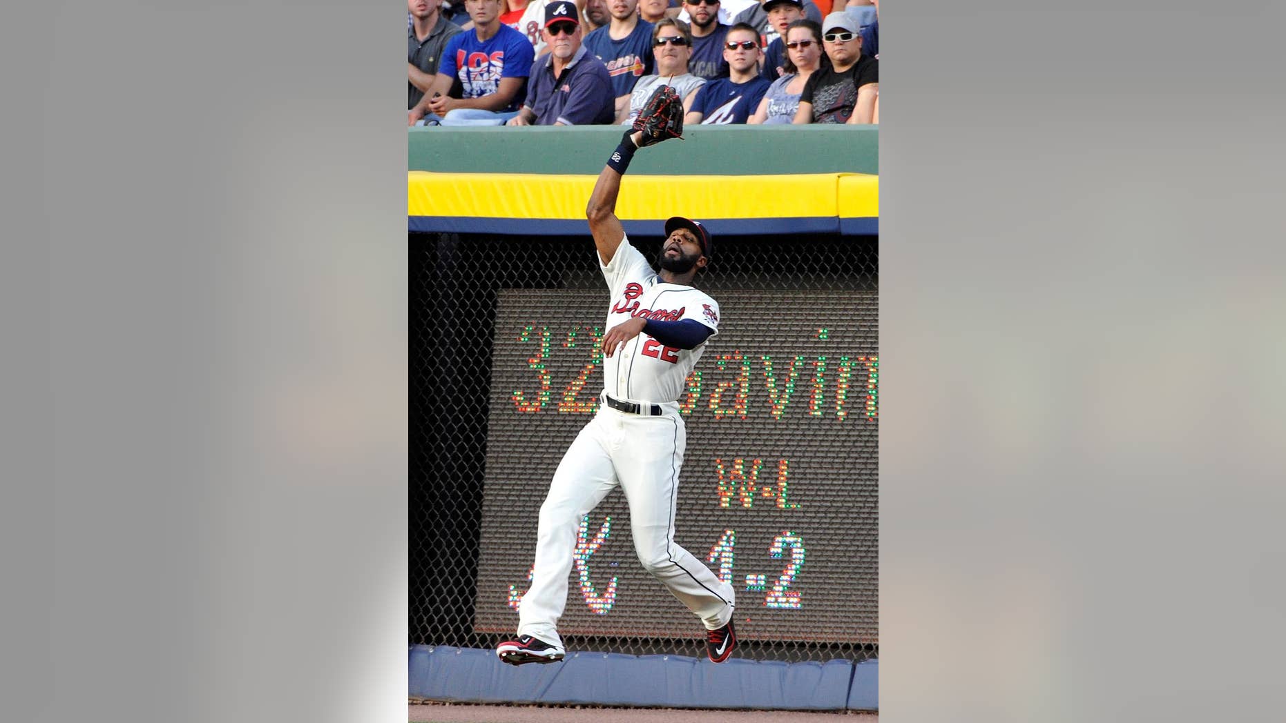 Atlanta Braves right fielder Jason Heyward fields a fly ball from Los Angeles Angels' David Freese for an out during the third inning of a baseball game on Saturday, June 14, 2014, in Atlanta. (AP Photo/David Tulis)